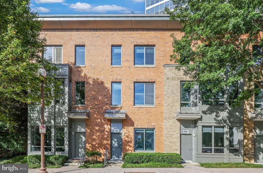 Massive price drop, come and buy this unit before it is gone!!!  Welcome to this rarely available luxury condo-style townhome—one of only ten at The Odyssey, one of Arlington’s most sought-after addresses. This unique residence combines the privacy and spaciousness of townhouse living with the convenience and amenities of a premier condominium community. Fully renovated from top to bottom in 2021, the home is truly move-in ready and showcases thoughtful modern upgrades throughout, including a brand-new water heater (October 2025).

Enjoy the ease of two private entrances: your front door opens directly onto N. Scott Street, while the rear entrance provides direct access from your reserved covered garage parking space (P2-023)—a rare and valuable feature in this location. The home also includes a private storage unit for added convenience.

Inside, you’re greeted by an open-concept layout with soaring 12-foot-high ceilings, abundant natural light, and beautiful engineered hardwood flooring spanning all three levels. The main level features a fully updated modern kitchen with white shaker cabinetry, quartz countertops, stainless steel appliances, and a tile backsplash, seamlessly flowing into the living and dining areas. Thoughtful touches include recessed LED lighting, a ceiling fan, and a remote-controlled switchable privacy glass window—offering the perfect balance of light and discretion. A stylish powder room with a quartz vanity completes the main floor.

Upstairs, the spacious primary suite includes custom Elfa closet organizers, a ceiling fan, and an updated full bath with quartz countertops and floor-to-ceiling tile. A front-load washer and dryer add practicality, while a built-in nook with shelving creates an ideal work-from-home space. The upper level features two additional bedrooms, both equipped with ceiling fans, perfect for guests or flexible use.

For entertainment enthusiasts, this home comes fully equipped with surround sound speakers, three wall-mounted TVs, movie theater seating, a high-top bar table set with stools, and a bar with a beverage cooler—all included. Window treatments and blinds will convey, allowing for a truly turnkey experience.

Residents enjoy full access to The Odyssey’s world-class amenities, including a rooftop terrace with panoramic monument views, a rooftop pool, a state-of-the-art penthouse gym, a party room with billiards, BBQ, and dining areas, secure package delivery, 24-hour concierge, and on-site professional management. The monthly condo fee includes water, maintenance of all common areas, and free Wi-Fi in shared spaces.

Ideally located in the heart of Arlington’s Courthouse-Clarendon corridor, this home is just one block from the Courthouse Metro (Orange & Silver Line), AMC Theatre, weekly farmers market, and an array of restaurants, cafes, and shops. You’re also less than a mile from Rosslyn Metro, MOM’s Organic Market, and the W&OD Trail, with easy access to I-66, I-395, Georgetown, and Ronald Reagan National Airport.

Offering an unmatched blend of style, privacy, and convenience, this exceptional Odyssey townhome delivers the very best of urban Arlington living with the sophistication of a high-end residence.