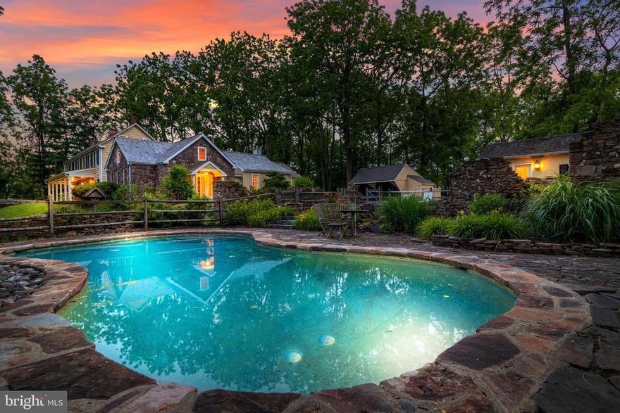 Everything you want in a country house is here in the peaceful green hills of central Bucks County.  Just minutes to Doylestown and New Hope, both home to countless small businesses, boutiques, arts and entertainment venues, and great restaurants; this solidly built, 18th-century stone farmhouse is situated off a winding road that exudes a calming rural ambience. A long driveway crosses over Paunacussing Creek and leads to an ideal, private retreat on more than 5 acres of beautiful grounds. The seamlessly integrated 21st century addition perfectly complements the original farmhouse with an open floor plan that has the spacious kitchen, complete with commercial-grade appliances and a rich mahogany island, flowing into a great room featuring a beautiful stone fireplace and a step-up informal dining area with two sets of French doors leading to a large, blue stone patio. Also, in the newer section of the home is the large, main-level master suite with a sunny sitting area or office space, and a delightful two-sided fireplace shared with the over-sized master bathroom. French doors lead from the master bedroom to a lovely garden terrace. Note the stairs leading to generous, unfinished space above the master suite that could either be finished or reconfigured into a dramatic cathedral ceiling. The large formal dining room, complete with butler s bar, library with enormous stone fireplace, and living room are in the original part of the house. All feature French doors that lead to the lovely terraces and gardens. The second floor consists of four additional bedrooms, all with hardwood floors, and two full baths. The third floor is an open, flexible space that offers endless use options-playroom, yoga or meditation space, hobby room-whatever you desire. A bonus is the heated in-ground pool & spa with a heated pool house, all very naturally integrated within the ruins of an old stone barn. This wonderful home is in the highly rated New Hope-Solebury School District less than an hour from Philadelphia and approximately 90 minutes from NYC. This is the perfect week-end retreat or a restful primary home with easy access to the New York, Princeton, Philadelphia business corridor.