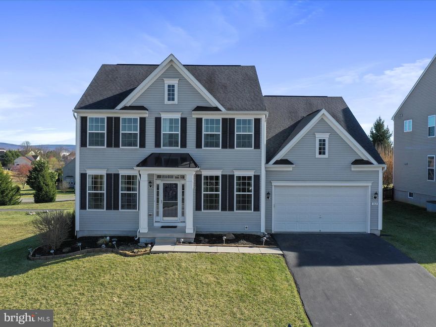 Welcome to your dream home! This stunning Colonial-style residence, built in 2013, offers a perfect blend of modern comfort and timeless elegance. Nestled on a generous 0.27-acre corner lot, this property has easy access to community paved walking path, and mountain views that will captivate you every day. Step inside to discover a spacious 2,596 sq. ft. layout featuring four inviting bedrooms and two and a half bathrooms. Elegant touches like crown moldings, chair railings, and recessed lighting enhance the interior, while gleaming hardwood flooring creates a warm and inviting atmosphere. The kitchen is equipped with modern appliances, including a electric range, dishwasher, and refrigerator, and stunning quartz counter tops ensuring culinary adventures are a delight.  The home has been remodeled with a fabulous butler pantry, you will appreciate the sleek style and ample prep and additional storage this space offers.  A low maintenance large deck off the sunroom is perfect for entertaining with stairs to your fenced back yard. Additional features include an unfinished basement with walkout stairs, perfect for customization, and a security system for peace of mind. The attached two-car garage offers convenience and ample parking. Located in a desirable area, this home combines comfort, style, and a picturesque setting. Don’t miss the opportunity to make this exceptional property your own—schedule a viewing today and experience the lifestyle you’ve been dreaming of!