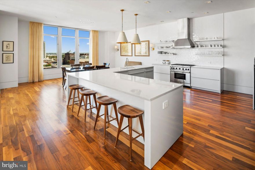 Surround yourself with panoramic skyline views at this light-filled penthouse in Philadelphia’s popular Western Union condominium building. A quietly elegant, bi-level retreat with three terraces high above the city, this residence is beautifully designed to offer expansive spaces for living and entertaining. There’s easy flow from living to dining to kitchen with wood floors throughout, high ceilings and a neutral palette. A gas fireplace and built-ins serve as the focal point in the living area, though the views are sure to compete for guests’ attention. A true cook’s kitchen is lined in Poggenpohl cabinetry, known for its timeless quality and smart storage solutions. Handle big events with ease via the six-burner Wolf range and supplemental Miele wall oven. A sleek wall of cabinetry hides the refrigerator/freezer, pantry storage and a wonderful secret bar with wine chiller and refrigerator/ice maker. In a quiet corner of the apartment is a study with a fireplace and a wall of sleek built-ins. This space can convert to a bedroom with ease. It has an en suite half bath plumbed for a shower should someone wish. Adjacent to it is an en suite guest bedroom with built-in armoire. A powder room, laundry room and plenty of closet storage complete the first floor. The second level offers access to three terraces, a generous amount of outdoor space for entertaining, container gardening or just enjoying those fabulous, sweeping views! Also on this level is the primary bedroom with a sitting area, yet another smartly designed space with an entire wall devoted to built-in storage outfitted with every manner of organizer. If you’re “a soaker,” look no further than the Victoria & Albert steeping tub in the main suite bath. This bathroom sports Poggenpohl double wall-hung vanity, tile wainscoting and an oversized shower with multiple sprays. With so much built into this home, it feels as livable as a large suburban home but with restaurants, theaters, the ballet, orchestra and galleries just a few minutes’ walk from your door. To make city life even easier, this penthouse includes two garage parking spaces and four storage units in the building.