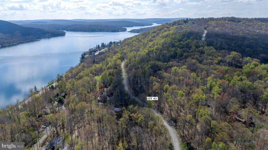 Beautiful lake access building lot in the popular community of Mountainside.  You’ll appreciate the convenience of this exceptional central lake location near Skiing, Golfing, Adventure Sports, State Parks, Dining, Entertainment, and all the exciting Deep Creek Lake resort amenities.  Enjoy Mountainside's fun Lakeside Clubhouse with spacious deck and incredible views overlooking an expanse of the main lake.  This large one-acre homesite is the perfect woodland setting for your new mountain cabin!