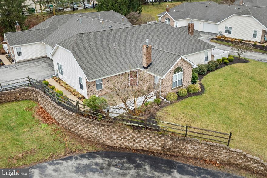 Come see 135 Village Way located in the desirable Villas at French Creek.   This 55+ community remains one of the best kept secrets in Phoenixville.   The upgrades in this 2- bedroom, 2 bath ranch style carriage home make it move in ready.   The open floor plan offers an entrance into the living room with palladian window, gas fireplace and adjoining dining room.  There are wood floors throughout.     New kitchen cabinets and laminate quartz-look counter tops make up the eat-in kitchen that leads to the laundry room.   There is convenient access to the garage through the laundry room.    The primary bedroom offers large walk- in closet and newly renovated ensuite with glass walk in shower.  A second bedroom has ample closet space and is often used as a den or sewing/craft room.   The hall bath has a tub/shower.   This elevated unit offers a view of Village Way while maintaining the privacy of your fenced patio.  The two-car garage in the rear that is accessed by the extended driveway and is equiped with an electric vehicle outlet.    Take advantage of the community amenities that include a clubhouse with a fitness room and an outdoor heated, saltwater pool available in season.   There are a variety of events planned by the Social Committee where you can meet and engage with your neighbors.  The residents enjoy easy access to French Creek Trail, nearby parks and, of course, the restaurants and shopping in historic downtown Phoenixville.    Schedule your showing today and enjoy the low maintenance lifestyle of the Villas at French Creek.