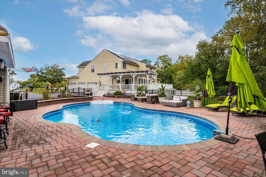 Welcome to Your Private Retreat on Windy Hill! Tucked away at the end of a quiet cul-de-sac, this stunning 6-bedroom executive home sits on 1.75 acres of beautifully wooded land, bursting with ornamental and fruit trees , including apple, weeping cherry, crepe myrtle, hydrangea, azalea, rhododendron, daffodils, foxglove, and more. In the spring, the property transforms into a vibrant garden paradise. The backyard is your personal oasis, featuring a gorgeous in-ground pool with water features, a fully equipped poolside bar and outdoor kitchen, big-screen TV, and two spacious storage closets. The pool has been recently updated with a brand-new pump and liner, ready for summer enjoyment. Inside, the home offers over 5,000 sq ft of living space, with an additional 1,700 sq ft walk-out in-law suite with a private entrance, mini kitchen, updated bath, and modern flooring, perfect for guests or multi-generational living. The main level boasts an updated kitchen with granite countertops, breakfast bar for 8+, modern flooring, and expansive windows overlooking the property and the brand-new Trex deck. The vaulted-ceiling living room with a gas fireplace is warm and inviting, complemented by a sun-filled formal sitting room with bay windows. You'll find two primary suites, one on the main level and one upstairs. The upper-level primary suite features hardwood floors, crown molding, a spacious walk-in closet (plus two additional closets), and a luxurious ensuite bath with jetted tub, new shower, and upgraded fixtures. Additional highlights include: Updated powder room with swan faucet and wainscoting, dual-sink secondary upstairs bath, two brand-new A/C units, and an established welcoming neighborhood. Whether you're entertaining by the pool, relaxing in one of the expansive living areas, or enjoying the peaceful wooded setting, this home offers a rare blend of elegance, comfort, and outdoor beauty. Professional pictures to follow