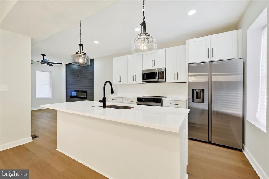 Welcome to 1918 N Bentalou St, a fully renovated 3-bedroom, 3.5-bathroom townhouse with bonus room in the basement, that’s truly move-in ready! This home showcases stylish fixtures, modern finishes, recessed lighting, and so much more. The main level features an open-concept layout with a bright living room highlighted by a sleek electric wall fireplace, a dining area, and a stunning kitchen complete with white shaker cabinets, quartz countertops and backsplash, and stainless steel appliances. A convenient half bath completes the main level. Upstairs, you’ll find three bedrooms, including a spacious primary suite with a beautifully tiled en-suite bathroom. Two additional bedrooms share a stylish Jack-and-Jill bath. The fully finished lower level expands your living space with a family/rec room, a bonus room perfect for an office or guest space, and an additional full bathroom. Don’t miss your chance to see this modern gem—schedule your showing today!