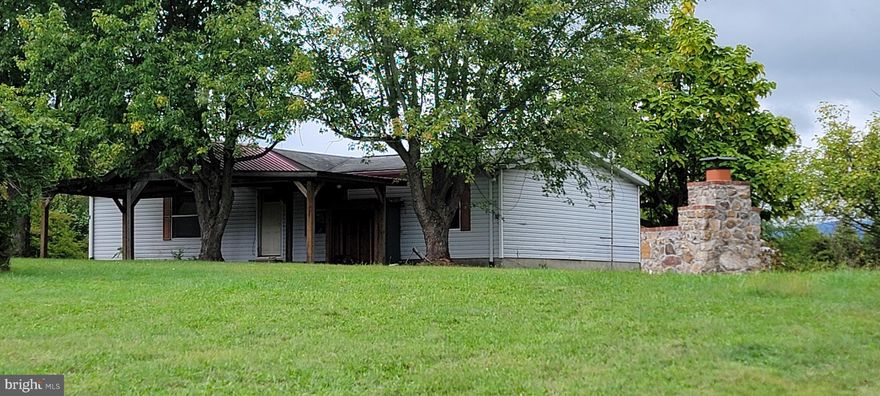 Almost 12 UNRESTRICTED acres with beautiful mountain views!  Beautiful cleared level lot with 3 bedroom 2 bath older double wide fronting county road for easy access.  Outdoor stone fire/grill.   Land is partially cleared with an easy gently sloped access path to rear of lot.  Separate right of way near rear of lot for easy possible sub-division.  Rear of property is partially cleared  and level for a beautiful building site.  Excellent hunting!  Ride your ATVs, farm or enjoy nature and the views!  Unlimited possibilities with this beautiful homesite!  Aerial photos coming soon!