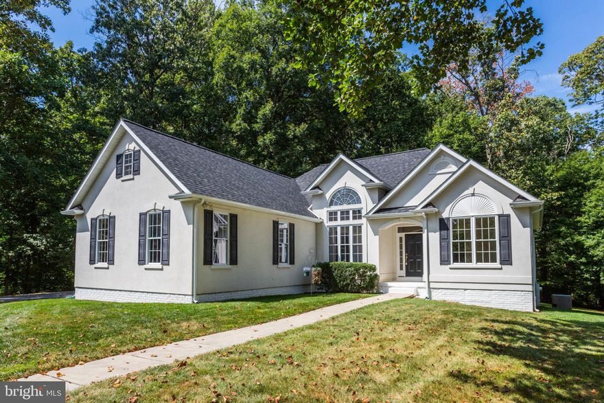 Find your personal haven in this remarkable and distinctive Custom Built Home by Viking Homes, situated on 2 lots totaling just under 5.5 acres with a tranquil stream. Notable Updates include: fresh paint throughout, new carpet and freshly refinished hardwood floors,  new dishwasher in May 2023, roof/gutters/covers in January 2022, water softener/sanitizer/neutralizer in December 2021, refrigerator in 2019, HVAC in 2017 (dual fuel heat pump and propane furnace with whole house humidifier), well pump and pressure regulation system replaced as well. Adjoins Schooley Mill park and Buck's Haven Stables so great for horse owners or anyone looking for privacy. Main Living Level is spacious bright and open with 9ft, Vaulted and Cathedral Ceilings. Expansive Living/Dining Room combination with a stone surround wood burning fireplace, large Kitchen with window lined Breakfast Room overlooking the lush, wooded,  private backyard and laundry Room with interior access to the oversized 2 car garage. Enjoy the luxury of an Entry-Level Primary Suite with new carpet, 8x6 walk-in closet and En-suite Full Bath with double vanity and relaxing jetted tub. Additionally on this level you will find 2 more Bedrooms with new carpet plus ample closet space and a hallway Full Bath. The sprawling Lower-Level is unfinished, with a walk-out to the rear wooded yard, storage room, rough in for a bathroom and possibilities galore! Located in the River Hill High School district and short drive to River Hill Village Center, Clarksville Commons, River Hill Square & Maple Lawn Marketplace.  Need to work from home?? Utility closet: Wired for Verizon FIOS/POTS and Comcast. Electrical Panel, Double run of ethernet to each room, Patch panel, Network switch. Coax runs to family and bedrooms may be used with cable or long-range antenna in attic (about 100 local channels). Easy access to major commuter routes 32/108/95/29. Do not miss the opportunity to own this Spectacular Custom Built Home and all of its Superb Features... additional wooded lot is designated non-buildable ... smart thermostat / garage door ... Schedule your showing TODAY!