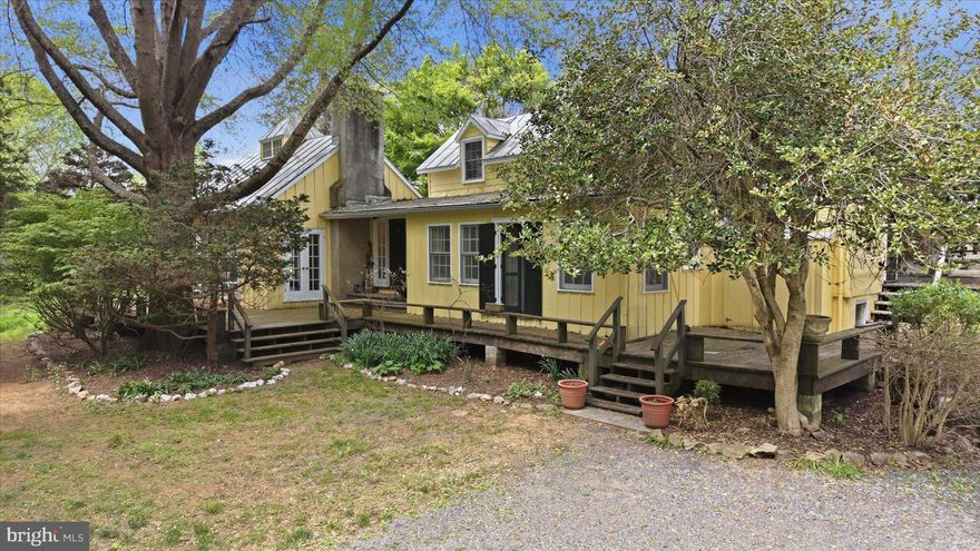 Located in the Orange County Hunt’s prized territory, this 16.397-acre parcel, comprised of level 
and gently rolling prime land, is 8 miles to Middleburg/Rt 50 and approximately the same to I-66 
in Marshall. The 800-foot gravel driveway is bracketed by woods, giving the property privacy from
Five Points Road. The natural beauty of a large pond welcomes you to the parking area and stone
wall that dates to the early 1800’s with the original section of the home. It was added to the
Nineteenth Century, modernized in the Twentieth and renovated in the 1970’s, so there are
(2) front entrances into the home.  Once inside, there is a handsome great room, a cheerful 
breakfast room nestled in between the kitchen and separate dining room, a main level “study”, 
a large upstairs storage closet, along with 2 bedrooms, and 2 full baths. The home is graced with 
upgrades that include a tin roof, solid wood flooring throughout, 2 wood-burning fireplaces, and 
exterior French doors in the great room which also has a beautiful wooden tongue and groove 
beamed cathedral ceiling. Other upgrades include an exposed log rafter ceiling in the large 
upstairs bedroom, a walk-in shower in the main level bath, and built-in shelving for books and 
treasured items in various rooms, adding to this home’s character and charm. The main staircase
that goes to the second-floor bedrooms and bath is original to the 1803 cottage. A creek meanders through the property that fills the pond before it goes through the marsh and culverts under the road 
to a large private pond across the way.   The outbuilding stores gardening tools for a once industrial -size cutting garden.  Decorative bushes and perennials define the living space from the open rear acreage that climbs gently to the highest point.  High speed internet is available through High Mountain Farm, LLC in The Plains, Va.