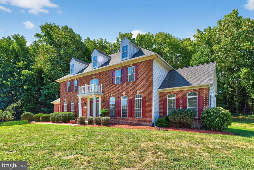 PRESTIGIOUS  WOODMORE HIGHLANDS  – Elegant 5 BR, 4.5 BA estate situated on stunning 1.21-acre lot and boasts of 6,514 square feet of luxury living.  Grand two-story foyer entry with decorative columns, wainscoting, crown molding, and refinished hardwoods. Sunlit living spaces with floor-to-ceiling windows and three fireplaces. Gourmet kitchen with center island, double wall ovens, and breakfast nook flows to a serene family room with cozy fireplace.  Do not miss the stunning sunroom and main-level office. Enjoy the luxurious primary suite with fireplace, two walk-in closets and a romantic fireplace. The finished lower level with b-i-g recreation room, wet bar, guest bedroom, full bath, theater room and plenty of storage. Oversized two-level deck ideal for outdoor entertainment. Exceptional craftsmanship and refined details throughout.