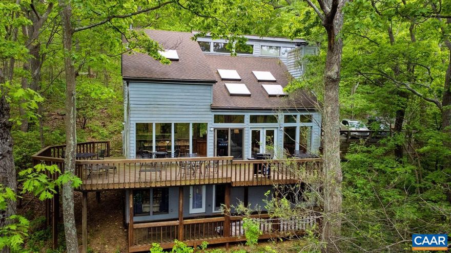 Step into this home and walk out on the deck. You just may have memories of Swiss Family Robinson as you relax amongst the treetops and feel the cool breezes as they swirl across the ridge lines. This home is in a prime location near the Tyro slope access and provides privacy away from the hustle and bustle of the Resort Village. Loads of potential for the large extended family, multiple families or the short-term rental investor. Not many homes boast 7 bedrooms and 5 1/2 baths with a master suite on each floor and two separate living areas. This home is filled with light with an array of windows and skylights. Even the darkest days are bright here! Seasonal views abound after the magnificent colors of the fall foliage. Act now at this special opportunity to experience mountain living.,Formica Counter,Wood Cabinets,Fireplace in Basement,Fireplace in Great Room