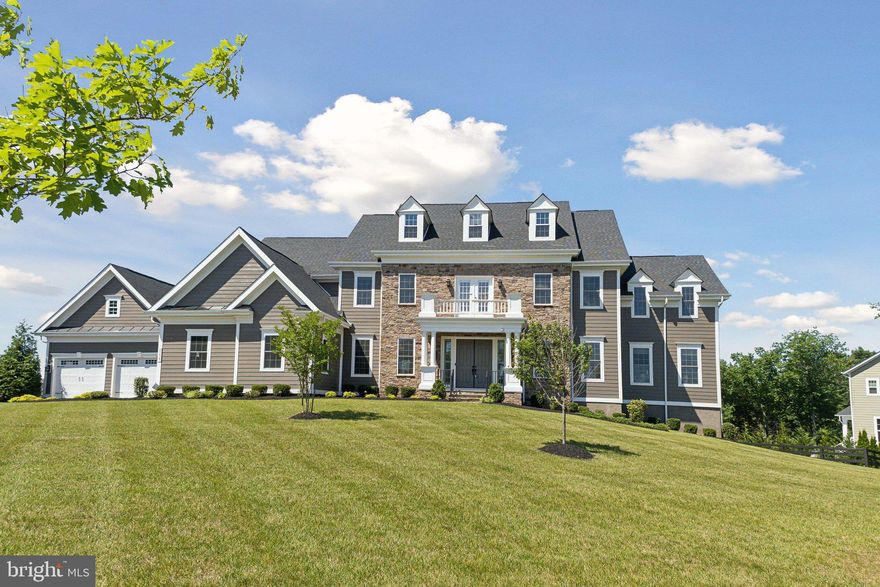 Welcome to your new home in the prestigious Greens South-Willowsford community. This magnificent Monticello II Model by NV Homes is situated on one of Willowsford's largest home sites, spanning over an acre and backing to serene woodlands, just moments away from The Greens Village amenities.


Boasting 9,224 square feet across three levels, this estate features seven bedrooms and seven and a half bathrooms and custom closets in EVERY closet. The main level impresses with a sophisticated curved staircase, high ceilings throughout, two home offices (one with built-in cabinetry), and a two-story family room with a coffered ceiling and gas fireplace, providing an ideal space for relaxation after a long day. The elegant kitchen is equipped with a large island, six-burner cooktop, double ovens, dual dishwashers, and a butler's pantry, seamlessly connecting to the morning room and dining rooms. Additional main level highlights include a large bedroom with an ensuite bath, a huge custom pantry and storage closet, a powder room, and a covered porch with inviting views of the surrounding landscape. An expanded mudroom with an informal front entrance and a four-car garage (outfitted with two 240 volt EV outlet chargers) provides added convenience and ample space for vehicles and storage.


Ascending to the upper level, discover the expansive owner's suite with a tray ceiling, a separate sitting area leading to a private balcony, and a designer master bath with dual vanities, a soaking tub, a luxurious walk-in shower for two, a water closet, and two huge walk-in closets customized by Closets by Design. You’ll also find four large additional bedrooms, each with en-suite baths and custom closets. A bonus living area provides extra space for relaxation or entertainment, and a large laundry room with a laundry sink and tons of cabinetry round out the upper floor.


The lower level includes a large recreation room with walkout access, a wet bar, a home theater with professional-grade equipment, a bedroom with a full bath, an exercise room, a large pantry with a refrigerator and three storage rooms.


Embrace the Willowsford lifestyle with two clubhouses, resort-style pools, splash parks, lush parks, gyms, a 7-acre lake with a boathouse, dog parks, maintained trails, sledding hills, campgrounds, and more. Join community events, cooking demonstrations, amphitheater concerts, and more. Willowsford, a 4,000-acre farm-to-table community with its 300-acre farm, garden, market, conservation areas, and miles of walking trails, is conveniently located less than 15 miles from Dulles International Airport and 35 miles from Washington, DC, and just minutes from top-rated schools, shopping, grocery, and dining.