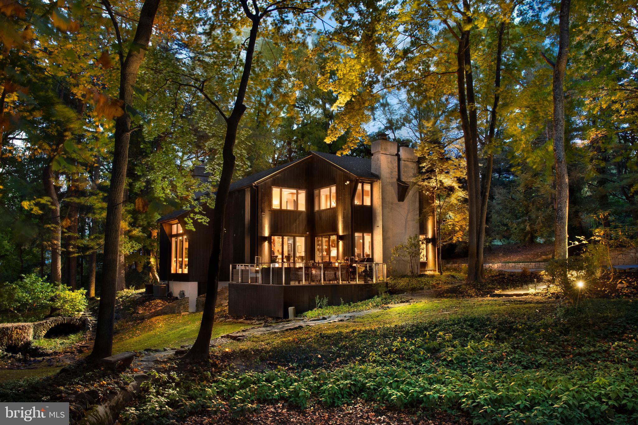 Introducing Stillpond, a secluded 2.27-acre haven located in the highly desirable, walkable St. Davids neighborhood, just minutes from downtown Wayne. This custom-built contemporary home offers 4 bedrooms, 2.5 baths, and an extraordinary landscape featuring a pond, cascading waterfalls, a stream, and a grotto with a charming stone bridge. This peaceful retreat blends breathtaking natural surroundings with modern luxury, highlighted by a new roof added in 2022 and the recent removal of many trees, creating an expansive, inviting yard.
Enter through double doors into a bright, sun-drenched two-story foyer with skylights and soaring ceilings. The spacious living room, with its floor-to-ceiling windows, offers stunning views of the landscape, complemented by a magnificent stone fireplace that extends to the ceiling. The buttress-beamed ceiling adds architectural interest, while custom-built wood and art display boxes enhance the room’s design. Fully renovated in 2024, this home showcases high-end European materials, reflecting a sleek, mid-century modern aesthetic. Stunning Valinge real wood flooring enhances the space with exceptional design, durability, and waterproof features. These floors are 3–5 times stronger than traditional hardwood, providing both beauty and long-lasting strength.
The newly renovated kitchen, imported from Denmark, boasts sleek cabinetry, heat-resistant DEKTON countertops, and state-of-the-art Samsung appliances, all synchronized via WiFi for ultimate convenience. Tall windows and bi-fold doors flood the space with natural light and open to a two-tiered deck, perfect for outdoor dining and entertaining, all while enjoying views of the beautifully landscaped grounds. The dining room’s bi-fold glass doors fully open to the deck, creating a seamless indoor-outdoor living experience. With its versatile layout, the dining room comfortably accommodates both casual meals and formal entertaining.
A spacious office could easily be converted into a bedroom, and features an atrium offering spectacular views of the property, a wine bar with Vinotemp-cooled wine storage, and custom oak bookshelves. The adjacent mudroom features a kitchenette, a side entry, a sink, and a doggy door leading to the fenced yard.
The floating hardwood staircase leads to a second-floor balcony overlooking the living room. The primary suite opens into a flexible space that could serve as a sitting area, home office, or exercise room. The bedroom itself features a cozy fireplace, two walk-in closets, and a spa-like en-suite bathroom with white Carrara tiles, double sinks, a walk-in shower, and custom German rainfall faucets. Three additional bedrooms and a beautifully updated hall bath, showcasing modern finishes and European influences, complete the second floor.
This home’s mechanicals are housed in a meticulously maintained utility room, which includes a Rain Bird irrigation system, central vacuum, security system, and Weil McLain boiler, with maintenance records available. A Kohler generator offers added peace of mind.
Located for easy access to major routes, including the 476 Blue Route, King of Prussia Mall, and Philadelphia International Airport, this home is just a short walk to St. Davids train station and downtown Wayne. Stillpond combines convenience, luxury, and natural beauty, offering an unparalleled lifestyle of privacy in one of the Main Line’s most sought-after neighborhoods.
With property taxes reassessed in 2021 at $19,904, this remarkable property awaits your personal touch.
* More photos will posted on Thursday, October 17th - photos of 3 more bedrooms, office, half bath, mudroom and workshop (behind the garage)