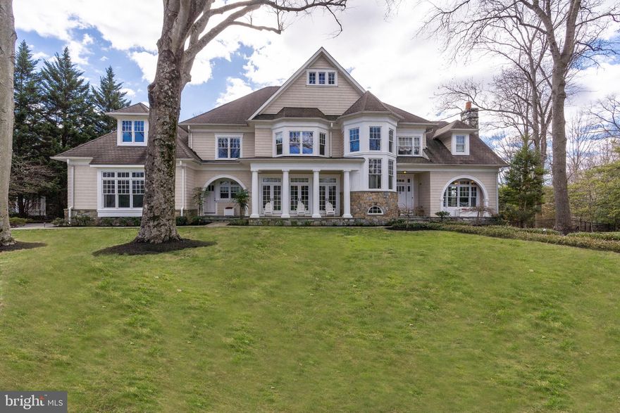 Presenting this stately, custom-built Augustine Homes Colonial nestled on a tranquil, 0.5 acre corner lot in Congressional Forest Estates, boasting 7 bedrooms, 5 full baths and 3 powder rooms with just over 8,000 square feet of living space. With a stately stone and shingle exterior, this home exudes timeless elegance and old-world European charm. A flagstone pathway cuts through lush landscaping to the inviting front door. Inside, the expansive foyer is flanked by formal living and dining rooms, and a library with custom built-ins. You’ll notice gleaming hardwood flooring and an abundance of natural light throughout the generously proportioned rooms. Towards the back of the home, the gourmet kitchen boasts chef-grade appliances, a large center island, a breakfast nook, and convenient butler’s pantry. The expansive step-down family/great room boasts coffered ceilings and a wood-burning fireplace. Two powder rooms complete this level. Upstairs, five spacious bedrooms and 4 baths await, including the generously sized primary suite oasis, complete with two large walk-in closets, a fireplace, and spacious primary bath. The magnificent walkout lower level boasts a wine cellar, wet-bar, game room, home theater, and guest suite with 2 additional bedrooms, a full bath, and a powder room. Walk out from the lower level onto a backyard oasis framed by mature plantings ensuring privacy. Enjoy the heated outdoor pool and large flagstone patio, sport court, outdoor pond, and tot-lot. A large motor court leads you to three garage doors with ample parking. An ideal location near Potomac Village, the vibrancy of downtown Bethesda, major commuter routes, and three major airports. This is a home without compromise, offering unparalleled luxury and comfort.