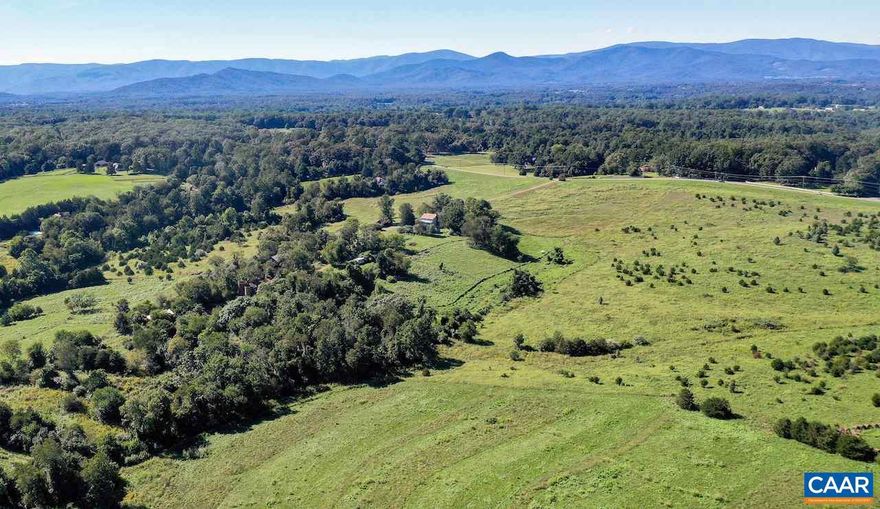 Remarkably large parcel located conveniently to Charlottesville and the University of Virginia as well as the shopping conveniences and airport on 29 North. Exceptional Blue Ridge views, charming farm house (in need of restoration), pond, and Jumping Branch, a clear stream traversing the property. Under VOF and ACE easement, but with some divisions.  Unique offering of large acreage with great convenience to Charlottesville, , or airport
