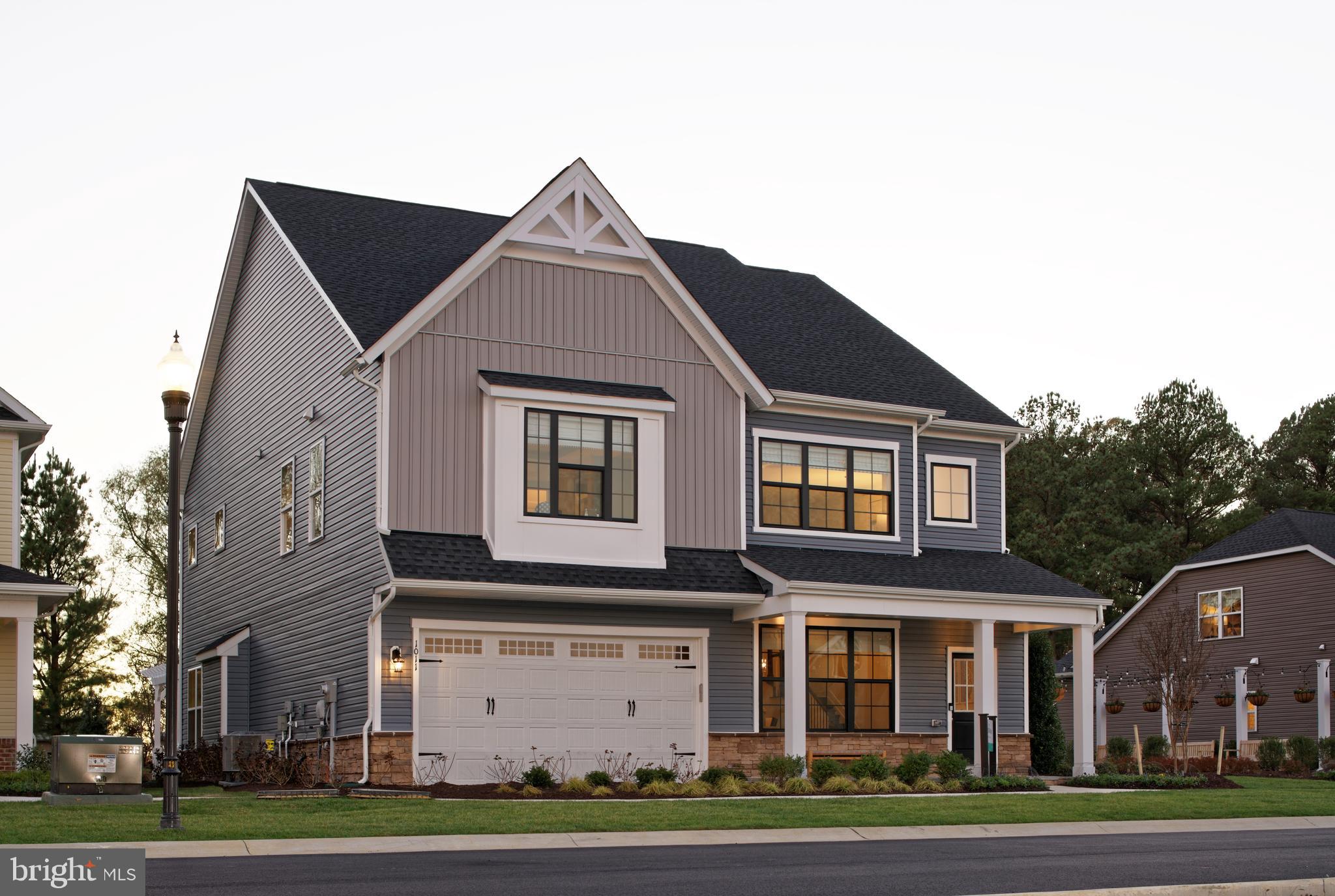Former Builder Model, the Beckham with 2 car garage is Ready for you to call home!
The dramatic 2-story foyer on the main level greets you and opens to a beautiful space you can transform into a formal dining or living room. Follow the hall as the home opens to the light-filled gathering space including a chef’s dream kitchen, grand room, and breakfast space.
The kitchen features a gourmet stainless steel appliances with a range hood, farmhouse style sink, white and moonshing cabinets, Carrara Marmi quartz counters, plus a walk-in pantry. The main level also boasts luxury laminate flooring throughout and additional windows in the great room providing you with an abundance of natural light. The grand room features a contemporary fireplace creating a cozy environment, and located off the grand room is an exterior patio. The private library is at the back of the home, perfect for a work from home office.
Take the oak stairs up, stained to a light gray, to the second floor where you will find a vast primary bedroom with dual walk-in closets, a stunning box ceiling detail, and an ensuite with a frameless shower door, dual vanity sinks, and a soaking tub.
A loft, three large secondary bedrooms with large walk-in closets, one with its own en suite, and a conveniently located laundry room loaded with cabinets, sink and side by side washer and dryer!
So many upgrades including trim, smart home package and custom landscaping. This is home!
Located in Trappe, MD just minutes from Easton, MD, Lakeside at Trappe is an amenity-rich community that allows for daily recreation and easy access to all your needs in Easton, Cambridge, and beyond.
Community currently offers a pool, bathhouse with fitness room, ping pong, corn hole and Bark park. Playground and racquet sports courts planned to open soon with an immersive lakeside experience also in the works!
