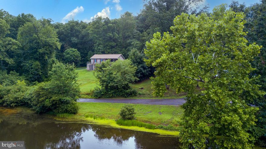 AMAZING PRICE ADJUSTMENT in RIXEYVILLE, VA - Culpeper County!  Looking for a Weekend Retreat or a Home that has a Weekend Retreat appeal?    Perhaps residential living in a scenic location?  Come to 10365 River Road in  Rixeyville, Virginia and enjoy the beautiful views .  Be sure to watch the video link,   Not only is this approximately 2,300 sq. ft.  home spacious, so is the front upper deck!  Under the deck it is enclosed with lattice and could easily be modified with the next owner into another outdoor area to enjoy more outside living!   If you are one that enjoys quiet serenity, privacy and a view of the pond near the Hazel River you may be it's next homeowner!  Watch the wildlife, birds and geese come alive.  The kitchen and  full bathroom have new flooring.  The back lot/yard is chain link fencing.  This home is sold in "as is" condition - which can be enhanced with a little tender loving care, fresh paint and your cosmetic touches to this home.    Must see to recognize and appreciate the value.  Amazing opportunity! (If your wondering...  Internet is Comcast X-Finity.  If you are concerned about your cellphones working at this location, let your internet provider know; click on WiFi Assist for Phones.   (Currently turned off) This street is one of the few in the area with internet access.   Make this your staycation!  Be sure to view the Survey, Video and Floor Plans!