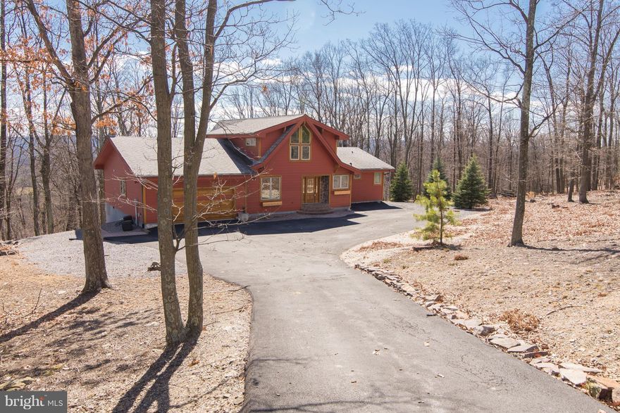 Light pours into this custom Lindal Cedar home with vaulted cedar ceilings & exposed beams flowing throughout this well-sited property backing to woods. Look out over mountain views in privacy through the wall of windows & on the rear deck. Stainless steel appliances, silestone countertops, hardwood floors, Possible 5 BRs with built-in Murphy Bed or in basement den.  Full membership available.