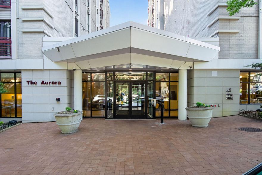 Welcome to the Aurora, a luxury condominium community thoughtfully converted to residences in 2006. Perfectly positioned on the edge of Washington, DC, this exceptional location offers easy access to downtown Silver Spring’s vibrant mix of shopping, dining, arts, entertainment, and year-round activities. This prime corner unit offers 1,032 square feet of beautifully updated living space and features high ceilings and floor-to-ceiling windows. Recent improvements include luxury vinyl plank flooring, plush new carpeting, fresh paint, two ceiling fans, a 2021 HVAC system, and 2021 water heater. The kitchen is open to the living area and enjoys maple cabinetry, granite countertops, breakfast bar, track lighting, pantry closet, and updated stainless steel appliances, including gas cooking. The primary bedroom suite features a generous walk-in closet with custom Elfa shelving and a private en-suite bath with a tiled shower. A spacious second bedroom offers its own Elfa-shelving equipped closet and has convenient access to the full hall bath. A stackable washer and dryer are conveniently located within the unit. Residents of the Aurora enjoy an impressive array of amenities, including a bright, welcoming secured lobby with seating, fitness center, social and community room with pool table, and a nicely landscaped courtyard with benches and tot lot. The Silver Spring Transit Center (Metro & MARC Rail) is located within one mile, and multiple nearby parking garages offer monthly parking options for a fee (Two of the nearest garages offer discounted parking permits for $95/month. Restrictions may apply.). The building is pet-friendly and gas and water are included in the condo fee. This residence delivers the perfect balance of comfort, convenience, and urban accessibility.