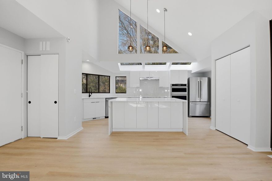 A truly stunning and impeccably renovated 3-level Contemporary single-family home offering 4 bedrooms and 4.5 baths in desirable North Reston. This architecturally striking residence blends modern elegance with refined finishes throughout.

The gourmet kitchen is a true showpiece, highlighted by soaring ceilings and skylights that flood the space with natural light. Premium stainless steel appliances include a wall oven and microwave combo, refrigerator, cooktop, designer range hood, dishwasher, and wine cooler. Quartz countertops, a dramatic waterfall center island, and high-gloss luxury modern cabinetry create a sleek and sophisticated statement.

Just beyond the kitchen, the home opens to a dramatic high-ceiling dining and living area filled with light and design-forward details, including a stylish accent wall—an ideal setting for both entertaining and everyday living.

The main-level primary suite offers exceptional convenience and luxury, featuring a spacious walk-in closet and a completely renovated spa-inspired bath with a freestanding soaking tub, glass-enclosed shower, oversized double vanity with a built-in makeup station, new toilet, designer mirrors, lighting, and new tile throughout.

A unique highlight of the primary suite is direct access to a private entertainment lounge complete with a wet bar, sink, and wine cooler—ideal for hosting or relaxing. This space also offers exterior access, enhancing flexibility and functionality. A modern powder room completes the main level.

Upstairs, two additional bedroom suites each feature newly renovated private baths—one with a standing shower and one with a bathtub—providing comfort and privacy for family or guests.

The fully finished lower level includes a fourth bedroom and a brand-new full bath with a shower, along with a spacious recreation room perfect for a media area, gym, or playroom.

Extensive updates include: New flooring throughout; Fresh interior paint; New designer light fixtures.

Enjoy walking to lake,  close to Reston town center,  hospital, etc. Can walk to the nearest restaurants.  Quick access to Fairfax County Parkway, the Dulles Toll Road, and Metro bus lines, along with walkability to the local elementary school. This home offers architectural distinction, lasting quality, and smart updates—all in an unbeatable location.

A truly special offering—this is the dream home you’ve been waiting for.