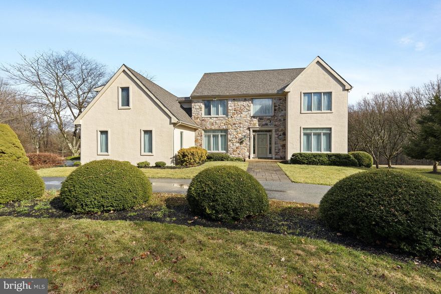 Set on a stunning and serene 1.2 acre lot in the much desired Millstream Ridge neighborhood of Kennett Square sits this pristine traditional 5 bedroom 4.2 bath home that has been lovingly maintained by its current owners. Enter from the circle drive and head up the brick paver path into the classic 2-story foyer with turned staircase. Immediately notice hardwood floors that run throughout the main floor and staircase. To the right of the foyer is a formal living room with an attached office with built-in shelving and access to the family room. To the left of the foyer, find the formal dining room. Continue through to the large eat-in kitchen with an abundance of custom wooden cabinetry with granite counters and backsplash as well as high-end appliances. Pass a glass slider to the deck into the large family room with vaulted ceiling, numerous windows allowing for loads of natural light, and a stone gas fireplace. Continue past the kitchen to an access hallway that leads to the main level laundry room that doubles as a full bathroom with walk-in shower along with access to the 3-car garage with large storage closet. This hallway also leads to a back staircase leading to the second level as well as a rear entrance to the large covered screened porch extension of the Trex deck overlooking the level private yard. Pass a powder room off of the foyer as you head up the main staircase to the luxurious owner's suite. The large bedroom boasts a vaulted ceiling and gas fireplace as well as massive a walk-in closet and 5-piece marble en-suite. Two additional well-sized bedrooms, both with walk-in closets, share an updated hall bath. Uniquely, this home offers an additional large suite with massive bedroom with gas fireplace, an abundance of closet storage (including another walk-in closet), en-suite, and 2 window benches with storage - perfect for an in-law or au pair suite. The finished walk-out lower level features a private office/gym, half bath, and bonus room with slider to a small outdoor patio. An abundance of unfinished space provides loads of storage opportunities. This beautifully maintained home offers solitude and privacy while enjoying close proximity to Longwood Gardens, downtown Kennett Square, Wilmington and all that the area has to offer.