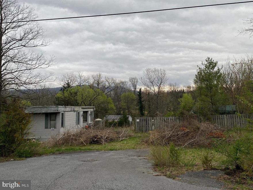Partially cleared level lot with a garage. Convenient location just off of Rivermont Drive. The mobile home on the property needs repair and is not habitable. The property is being sold AS IS.