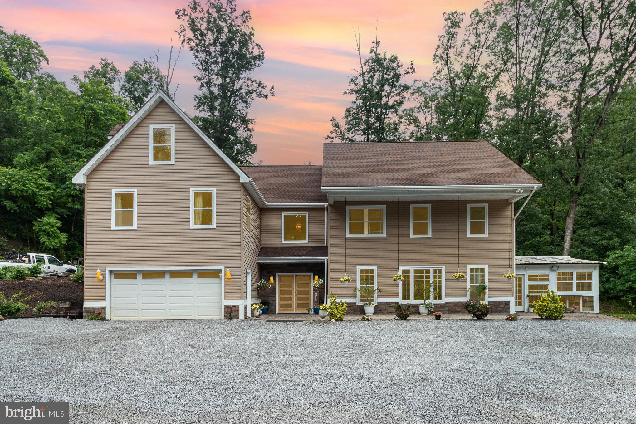 Discover a private, modern retreat nestled at the base of North Mountain in the Cumberland Valley School District. With over 4,000 sq ft of beautiful living space, more than 1,000 sq ft of garage space, and nearly an acre of land, this home offers rare versatility. A portion of the property fronts Route 34 with level ground, ideal for an additional building, storage, or work vehicles, while the main home sits back along a secluded private drive. Step inside to an open-concept living area with vaulted ceilings, sleek finishes, and abundant natural light. The contemporary kitchen flows into a spacious dining and living area, perfect for entertaining. The home features four to five bedrooms and three full baths, including a stylish primary suite with a tiled shower, soaking tub, and walk-in closet. A finished bonus room upstairs offers 400 sq ft of flexible space, and an additional 900 sq ft on the lower level is fully insulated and ready for your customization. Enjoy outdoor living in the pergola-covered barbecue area or enclosed sunroom. With an integral garage, remodeled interiors, and a layout that fits today’s modern lifestyle, this property is a true hidden gem just minutes from town, schools, and major routes. Let's schedule your private showing today.