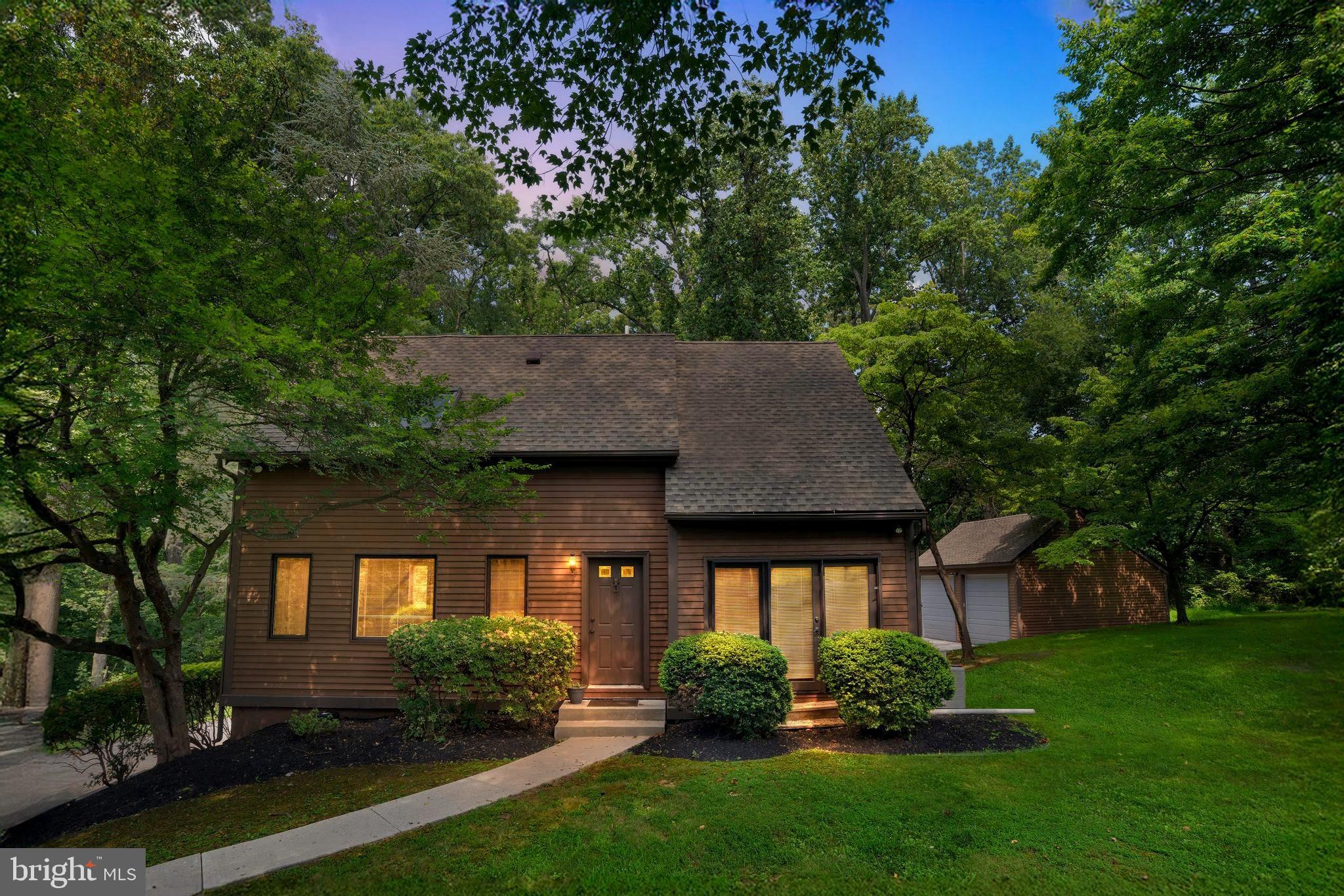 Welcome to 20 Jug Hollow Road, an exceptionally rare rental opportunity where privacy meets convenience. Nestled on 2.6 lush acres just minutes from Route 23 and Valley Forge, this beautifully updated home offers the feel of a countryside escape while keeping you close to everything. Step inside to find sun-filled living spaces with exposed beams, wide-plank wood floors, and walls of windows that frame the surrounding greenery. The open-concept kitchen has been tastefully updated with white cabinetry, butcher block counters, and stainless steel appliances. The two spacious bedrooms, including a vaulted primary suite, are paired with modern, spa-like bathrooms. A finished basement adds flexible space for a home office, fitness area, or media room. Outside, the property opens to an expansive green space surrounded by mature trees, perfect for entertaining, relaxing, or enjoying nature in total seclusion. A detached two-car garage provides plenty of storage and room for hobbies, with additional driveway parking available. Whether you’re seeking tranquility, room to spread out, or quick access to major routes and local amenities, 20 Jug Hollow offers it all in one unmatched package.