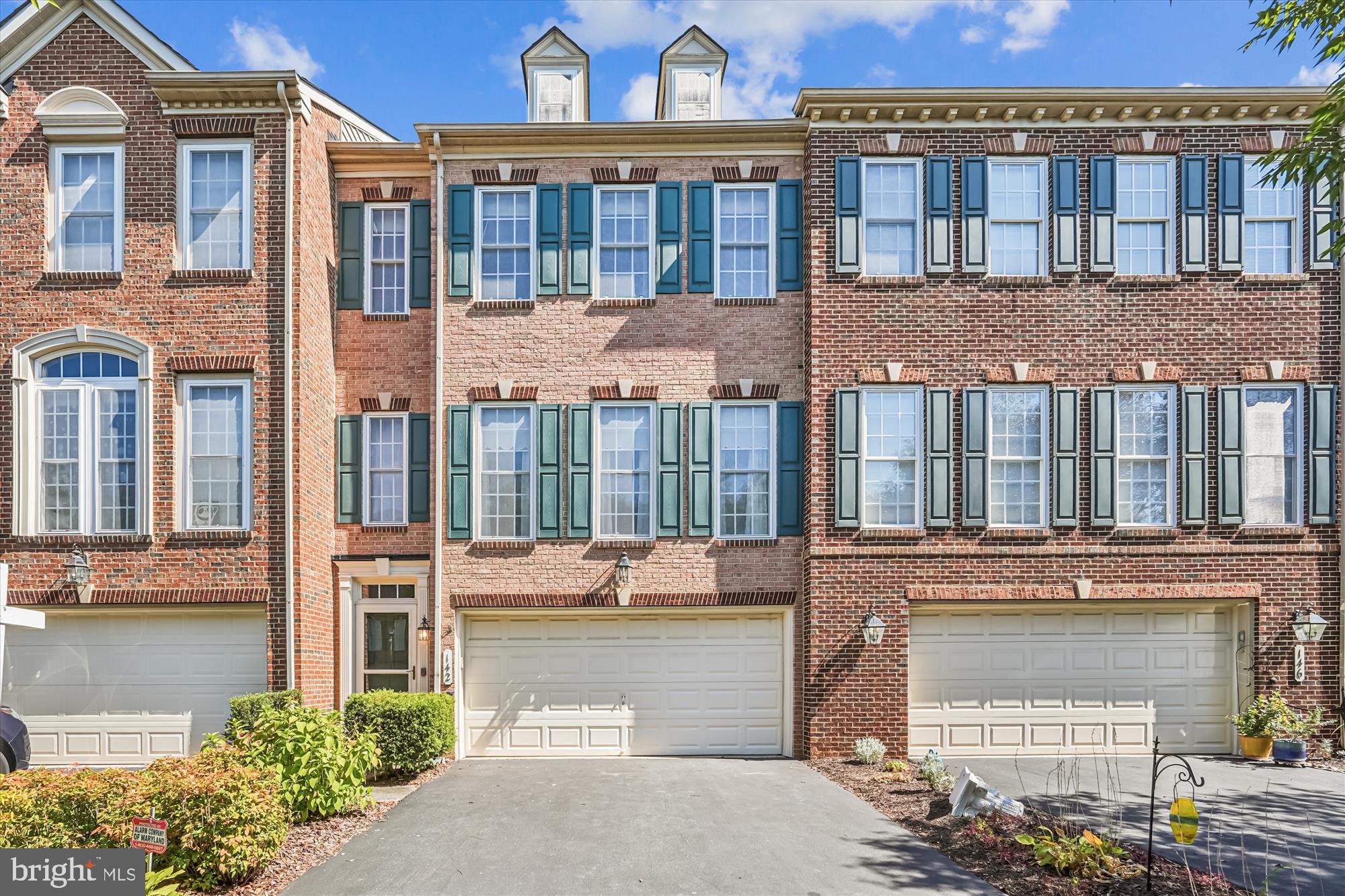 Welcome to this elegant, light-filled brick townhome with a two-car garage in sought-after Quince Orchard Park. With a 2’ bump-out on all three levels, the home offers more living space than reflected in the tax records. Recent updates include HVAC (2021), hot water heater (2018), garage door opener and keypad (2019), driveway resealing (2023), shutters (2018), fresh paint (2025), and brand-name stainless appliances. The entry level provides remarkable flexibility, featuring a spacious multipurpose room with an updated full bath, floor-to-ceiling windows, recessed lighting, ceiling fan, and generous closets. This level also includes the laundry/utility room, access to the garage, and glass patio doors opening to a fenced backyard with a newly installed 20’ x 10’ concrete paver patio and French drains—perfect for outdoor entertaining. On the main level, natural light pours into the living room with its dramatic floor-to-ceiling windows. A striking three-sided marble gas fireplace framed by decorative columns connects the living, dining, and gourmet kitchen & breakfast area, adding both warmth and architectural interest. The spacious gourmet kitchen features a center island with sealed granite counters, light oak cabinetry with updated hardware, stainless sink (2014), and a suite of stainless appliances—Bosch dishwasher (2023), KitchenAid double oven (2019), LG French door refrigerator with bottom freezer (2021), and range hood (2020). A luxury vinyl plank floor (2021) completes this inviting space, which also includes a sunny breakfast area with ample windows, transoms, and glass patio doors. Upstairs, the owner’s suite offers vaulted ceilings, a soaking tub beneath a large window, separate shower with frameless glass door (2018), and dual sinks with a marble-topped vanity. Two additional bedrooms and a second full bath provide comfort and versatility. Quince Orchard Park residents enjoy walking paths, a community pool, tennis courts, and Discovery Park. The neighborhood is ideally located just minutes from the Kentlands’ vibrant shopping and dining, with easy access to I-270, 370, and the ICC.