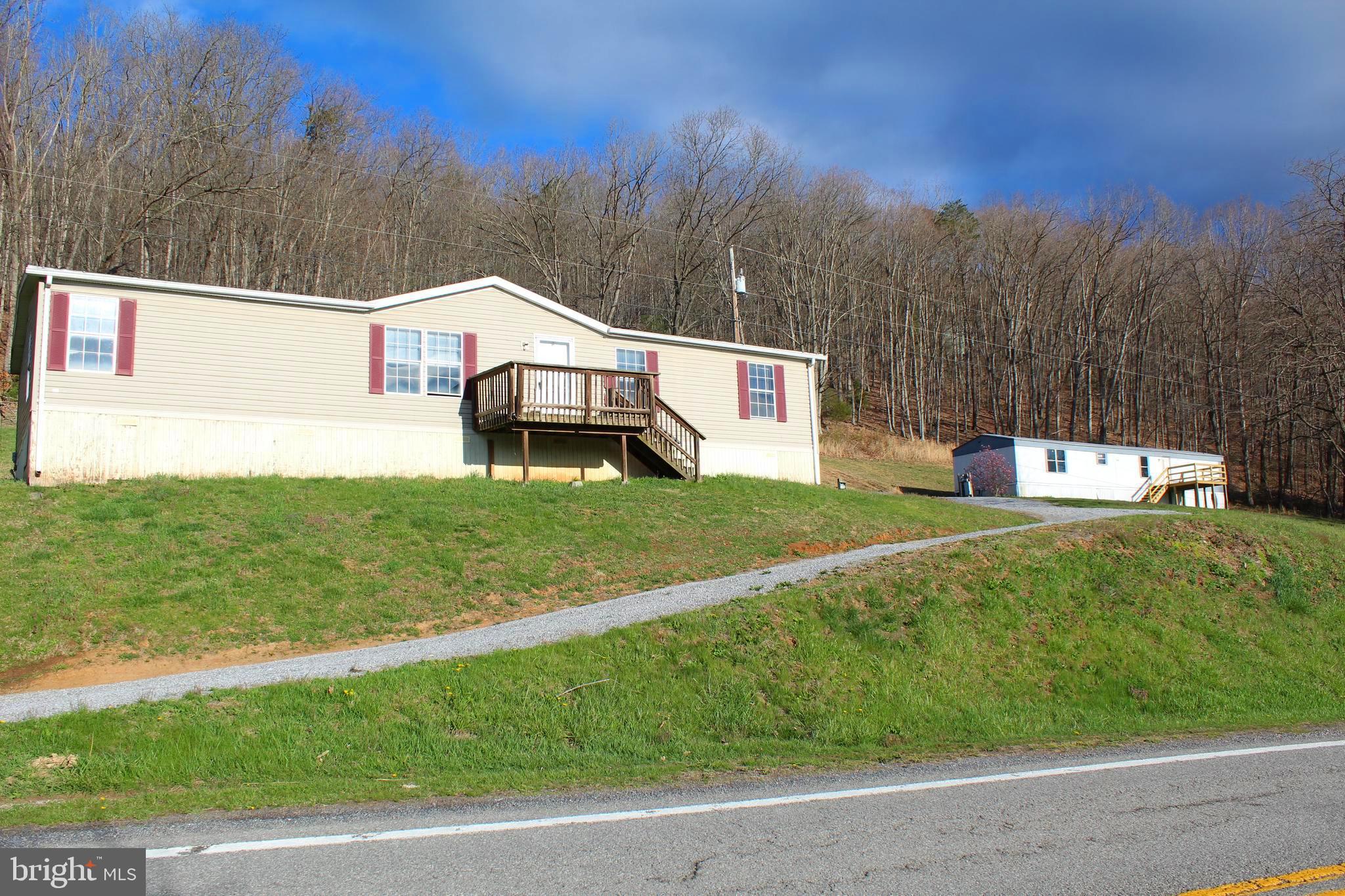 NEW PRICING!! Located in SCENIC Pendleton County where the mountains seem to dance in the distance. This property doesn't just boast gorgeous mountain views, it adjoins them! 7 + acres that BORDERS the MONOGAHELA NATIONAL FOREST and situated at the mouth of the famous SMOKE HOLE. Your backyard just got HUGE with easy access into the National Forest. Outdoor adventures could truly be endless with this property. Hunt, Hike & Explore in your backyard and beyond! If fishing is what reels you in, you are in the heart best trout fishing in West Virginia! Rehab the homes (doublewide and singlewide) and you could make this your mountainside retreat or short term rental properties! Property is being sold "AS IS". Call the mountains Home and the National Forest your back yard & never miss an adventure! Call today for a showing!