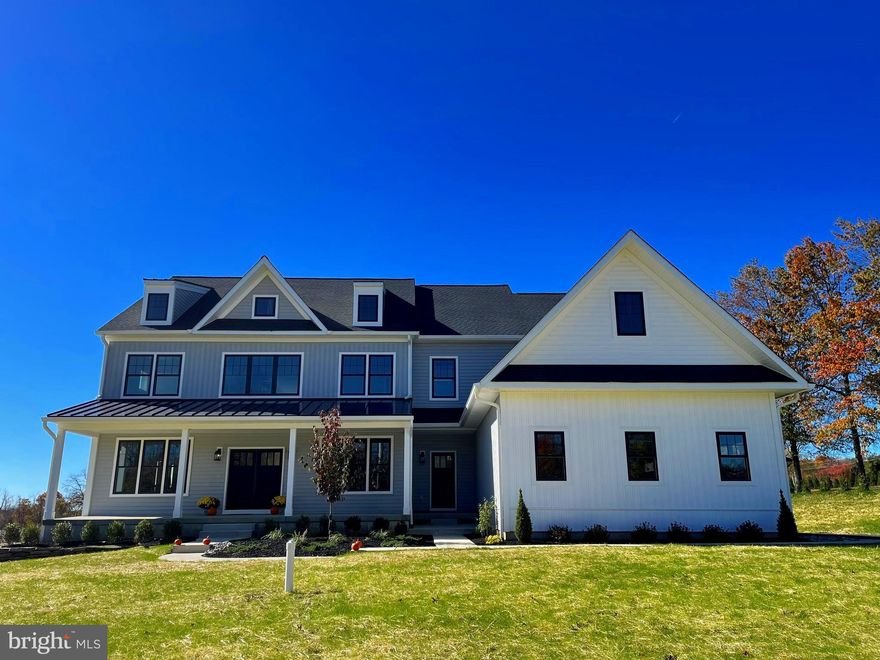 New construction without the wait. This 5-bedroom, 5.5 bath modern farmhouse is ready now! The home is loaded with luxury standard features and appointments built by an experienced team of professionals committed to superior craftsmanship. With an astute attention to detail utilizing only quality materials befitting of luxury living, Corsini Custom Homes pride themselves on delivering a beautiful product for today’s modern lifestyles. The flexible open floor plan includes dramatic 9’ ceilings throughout the house and custom millwork. Hardwood flooring graces the first floor, double staircases and second floor hallway. When you walk in the front door to the two-story open foyer, to the left is the fifth bedroom with en suite bath that can be used as an office. To the right is the lovely dining room with crown molding and board and batten millwork. The gourmet kitchen boasts custom built-in furniture quality kitchen cabinets featuring adjustable shelves and soft-close drawers. The oversized island includes an overhanging breakfast bar for seating and quartz countertops. The kitchen features high end appliances including a 6-burner stainless gas range, double wall oven, built in microwave and stainless refrigerator. Round the corner to custom cabinetry in the pantry and laundry room. A wood burning fireplace with farmhouse mantle warms the family room. Off the family room is a lovely, covered porch for outdoor entertaining. The second-floor features two adjacent bedrooms that share a Jack and Jill bathroom. Walk down the hall to the third bedroom with an en suite bath. The primary bedroom rounds out the second floor and includes a dramatic and beautiful bathroom with soaking tub, super shower and two water closets. In addition, there are two primary walk-in closets, a quiet sitting room and multiple areas for storage off the primary bedroom. This home includes a partially finished basement with recessed lighting and a finished full bath. The 3-car side entry garage is pre-wired for an Electric Vehicle charging station and upon entry into the home you are greeted with a stunning mudroom with custom storage bench. In addition, the house it is pre-wired for a generator, security & alarm systems, cable & internet. The home has PUBLIC sewer, private water, and NO homeowner’s association. It is conveniently located near 611 and in the award-winning Central Bucks School District. Call the listing agent today to schedule a private tour!