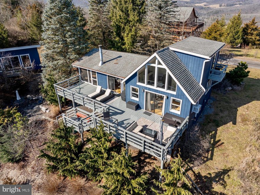 Discover this meticulously maintained 2-bedroom, 1-bathroom A-frame cabin boasting spectacular 360-degree mountain vista views. Nestled in the most sought-after property association, this home features a private loft second bedroom and a charming stone fireplace.

Enjoy the great outdoors on the expansive 800ft of open-air decks and a screened porch, providing ample space for relaxation and breathtaking moments with family and friends. There is also a studio that could be used as an office or a place for yoga. The property's versatile potential makes it an ideal candidate for a successful short-term rental income. Offering High-speed Fiber Optic internet service for those who can work remotely.

Situated on 5.01 acres, this haven is conveniently located just 15 minutes away from local shops and dining in the Lost River Valley. Additionally, it's a short 30-minute drive to Wardensville, where you'll find a newly established restaurant, inviting coffee shops, a delightful bakery, and a garden market offering freshly grown local produce.

Indulge in the tranquility of nature without sacrificing modern conveniences – this residence offers the perfect blend of seclusion and accessibility.