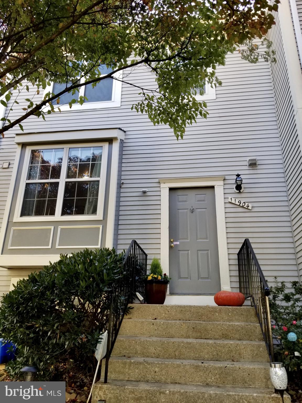 GREAT VALUE! This beautifully updated townhome is MOVE-IN READY and offers countless features including an updated kitchen with brand new SAMSUNG and Whirlpool stainless steel appliances; separate living and dining room spaces; lots of natural sunlight from every angle; gleaming hardwood floors throughout; and powder room. 2 generously sized bedrooms grace the upper level with a fully renovated bathroom equipped with all new fixtures, tiles, cabinets, jetted tub, shower with water filtration, toilet and moisture sensing exhaust fan. You ll love entertaining guests on the expansive deck, (one of the largest in the community) completely stained and refinished in September with stairs that walkout to the patio. The lower-level is a huge hit with its finished walkout basement expertly tiled with white engineered wood flooring, and loaded with tons of rec, storage space, and custom built-ins; tankless water heater with new heavy gage supply wiring and dedicated circuit breakers; whole house water filter and 3-stage filtration with UV light; completely restored & repainted front exterior window trims, panels, and side posts; re-insulated and easily accessible attic provides additional storage space. This home comes complete with 1-assigned parking space, 4 permits to park on unreserved spaces for additional vehicles and guests. Don't miss your chance to own this great starter home in a great location, at a great price!