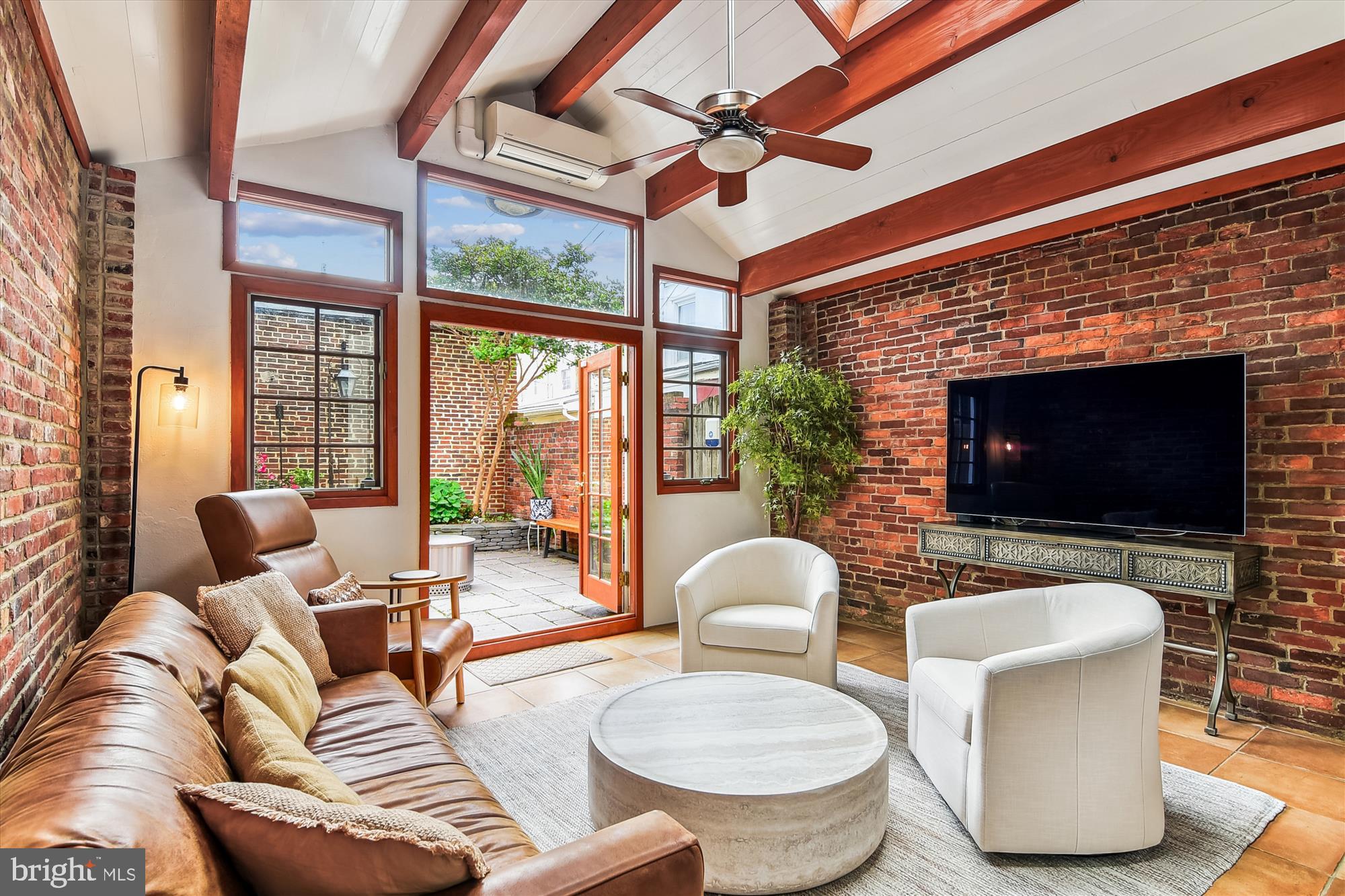 Experience Quintessential Modern Living in the Heart of Historic Baltimore. Step into this breathtakingly renovated residence, where timeless charm meets contemporary sophistication. Thoughtfully designed for both comfort and style, this exceptional home blends elegance and functionality across every level. From the moment you enter, you're welcomed by a warm, inviting ambiance that sets the tone for the refined details found throughout. The expansive living and dining areas are perfect for entertaining or enjoying quiet evenings at home. Large windows flood the dining room with natural light, ideal for both celebratory dinners and casual gatherings. Continue past the stunning powder room (renovated in 2024) to the heart of the home: a newly reimagined eat-in kitchen. Anchored by a large center island and luxurious quartz countertops (2024), this chef’s dream features a professional 6-burner Viking range and a 150-bottle wine refrigerator. The kitchen flows seamlessly into the family room, where radiant heated tile floors, exposed brick walls, and a double-sided Simplifire fireplace add both comfort and character. Step into your private courtyard, a serene escape from the city. Sip coffee on the patio, unwind under the stars, or host unforgettable alfresco dinners. This space is complete with a gas grill hookup and a handcrafted “BEVOLO” brass gas lamp from New Orleans, lending a unique artisanal touch. Two staircases lead to the second level, where the spacious primary bedroom offers a peaceful retreat. Two full bathrooms, beautifully renovated in 2024, exude modern elegance with sleek fixtures and finishes. A central laundry area adds everyday convenience, while a large family room provides flexible space for work, relaxation, or recreation. The top floor, accessed via two additional staircases, features two generously sized bedrooms with soaring 9.5-foot ceilings. The rear bedroom boasts a stunning view of the iconic Domino Sugar sign, a distinctive nod to Baltimore’s rich history. Additional Features Include: Three HVAC zones, including a new 2-ton heat pump (2024); New roof over the family room (2024); Opportunity to lease a parking space directly behind the home; Otterbein Swim Club transferable membership included with the sale. This is more than a home, it's a lifestyle. Set in one of Baltimore’s most cherished neighborhoods, this residence offers the perfect balance of modern luxury and historic charm. Welcome to your dream home.