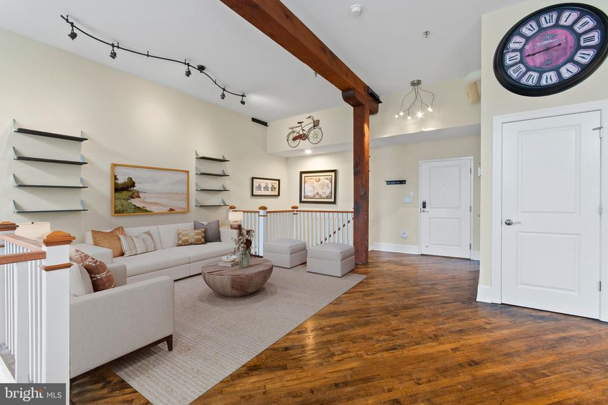 Experience distinctive loft-style living in the historic Shurs Lane Mills in the heart of Manayunk. This spacious bi-level condominium blends architectural character with thoughtful modern updates, featuring soaring ceilings, exposed beams, oversized windows, and rich hardwood flooring throughout the main living areas.

The upper level offers a bright, open-concept layout ideal for everyday living and entertaining. The living and dining areas flow seamlessly into the kitchen, which features granite countertops, cherry cabinetry, stainless steel appliances, and a convenient breakfast bar. A powder room is also located on this level for guests.

The lower level provides a comfortable and private retreat with two well-sized bedrooms and two full bathrooms. The primary suite includes an en-suite bath, while the second bedroom offers flexible space for guests, a home office, or additional living needs. A dedicated laundry area with washer and dryer is also located on this level.

Recent improvements include a new HVAC system installed in 2024, along with updated fixtures and professionally installed appliances, providing added efficiency and peace of mind.

This unit includes two deeded parking spaces in a gated lot, a rare and valuable feature in this area, along with additional street parking nearby. Monthly condo fees cover water, sewer, trash, exterior maintenance, snow removal, building insurance, management, and gated parking.

Located just minutes from Main Street Manayunk, residents enjoy convenient access to restaurants, shopping, parks, and the Schuylkill River Trail, along with nearby public transportation and easy commuting to Center City Philadelphia and surrounding areas.

This property is eligible for up to a $5,000 lender credit toward closing costs for qualified buyers.

Offering a unique combination of architectural character, modern comfort, and a highly convenient location, this home presents an exceptional opportunity to own in one of Manayunk’s most distinctive condominium communities.