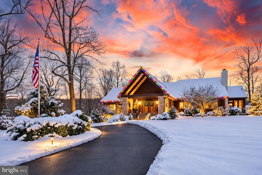 Ever dreamed of living at your own private resort where you make the rules? Welcome to an extraordinary estate set on 3 beautifully landscaped acres with a front-row seat to the rolling greens of Phoenixville Country Club. This one-of-a-kind property is thoughtfully arranged as a private compound with three distinct buildings including the main residence, a detached pool house, and a separate guest home, creating incredible flexibility while maintaining a warm and inviting feel. The centerpiece of the property is the spectacular two-story Wellness Pavilion located within the detached pool house, featuring a heated saltwater indoor pool with diving block and stone slide, hot tub, cold plunge, steam room, sauna, wet bar, and two full baths. Skylights and walls of glass flood the space with natural light while doors open to a sun-drenched patio designed for pool parties, entertaining, or peaceful relaxation. The main residence is a Craftsman-style raised ranch offering approximately 3,900 square feet above grade with an additional 1,920 square feet of beautifully finished lower-level living space. Post-and-beam architectural details, soaring ceilings, and expansive windows fill the home with natural light and frame the dramatic central dining room highlighted by a trio of chandeliers. The gourmet kitchen features both a peninsula and center island along with a Viking gas range, two Viking dishwashers, and GE Profile refrigerator, opening seamlessly to the inviting family room where a striking stone fireplace creates a warm focal point. Just off the kitchen, the sunlit breakfast room includes a built-in coffee station with mini refrigerator, sink, and ice maker. The primary suite offers private deck access, a spa-inspired bath with soaking tub and double vanity, and a walk-in closet designed to finally give your wardrobe the space it deserves. The walk-out lower level feels more like a private club than a basement with a full wet bar featuring white cabinetry, quartz countertops, dishwasher, two ice makers, two wine refrigerators, sink, and tiled backsplash along with a wine cellar, game room, TV room, two offices, full bath, mudroom, and access to the oversized two-car garage. Complementing the estate is the detached pool house surrounding the Wellness Pavilion as well as a charming 677 square foot guest home offering two bedrooms, two full baths, dining room, bright family room with sliding doors to its own private deck, full kitchen, and laundry making it ideal for extended family, guests, or long-term visitors. Outdoor living is just as impressive with a massive brand-new composite upper deck featuring a waterfall and gazebo overlooking the private backyard and golf course beyond. Additional highlights include new decks, newer roof, new driveway, water filtration system, and even a charming chicken coop tucked into the landscape. Located just minutes from Valley Forge National Park and the vibrant restaurants and shops of downtown Phoenixville, this is a rare opportunity to own an estate that truly redefines what home can be.