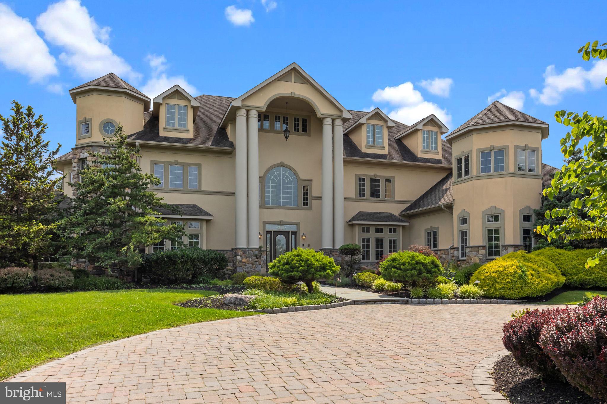 Welcome to the stunning 2 Aldans was in the sought after Council Rock School District. Step into timeless elegance and exceptional design in this expansive 5-bedroom, 6.5-bath residence offering four levels of meticulously crafted living space, a total of five garage spaces, and an outdoor retreat that rivals a private resort.
From the moment you enter, you're greeted by a dramatic dual curved staircase framing the two-story foyer, where a stunning chandelier and custom trim moldings make a striking first impression. Overhead, the open upstairs landing offers beautiful sightlines over the entry, setting the tone for the grandeur throughout the home.
The heart of the home is the upscale kitchen, featuring a wood-paneled refrigerator, large center island, gas cooktop, walk-in pantry, and butler’s pantry with a wine fridge. A built-in workstation with a desk adds functionality, while multiple dining areas—including a formal dining room, breakfast nook, and island seating—offer the perfect setting for everything from casual meals to elegant entertaining.
The sun-drenched two-story family room is anchored by a cozy fireplace and enhanced by a curved rail overlook above. Nearby, a main-level office with custom built-ins provides the perfect work-from-home setup, and a separate flex room—ideal for a pool table or game room—features its own wet bar and leads down to the finished basement.
Upstairs, the luxurious primary suite offers a private retreat complete with a sitting area, dual vanities (each with 10 drawers and ample cabinetry), a spa-like soaking tub, custom tiled shower with bench and double shower heads, and a designer walk-in closet with built-in drawers and shelves.
The finished basement continues to impress with a wine tasting room, home theater, family room, wet bar, full bath, and a 6-person sauna. The top (attic) level offers three versatile flex spaces—perfect for game rooms, guest overflow, or a peaceful yoga studio.
Functionality meets thoughtful design in the rear entry hallway, which features a mudroom with built-in lockers, closet, and a spacious laundry room with pantry-style cabinets and a utility sink.
Outside, the professionally landscaped, fenced-in backyard is a showstopper. An in-ground pool with attached hot tub is surrounded by lush greenery, an expansive slate patio, and a covered lounging area beneath the upper-level deck. A charming gazebo houses a full outdoor kitchen, complete with grill, griddle, vented hood, mini fridge, ice maker, dishwasher, and bar seating—perfect for outdoor entertaining all year long.
With a 4-car detached garage and an additional 2-car detached garage, there's no shortage of space for vehicles, hobbies, or storage.
This exceptional property offers the perfect blend of luxury, comfort, and functionality—an entertainer’s dream and a true place to call home.