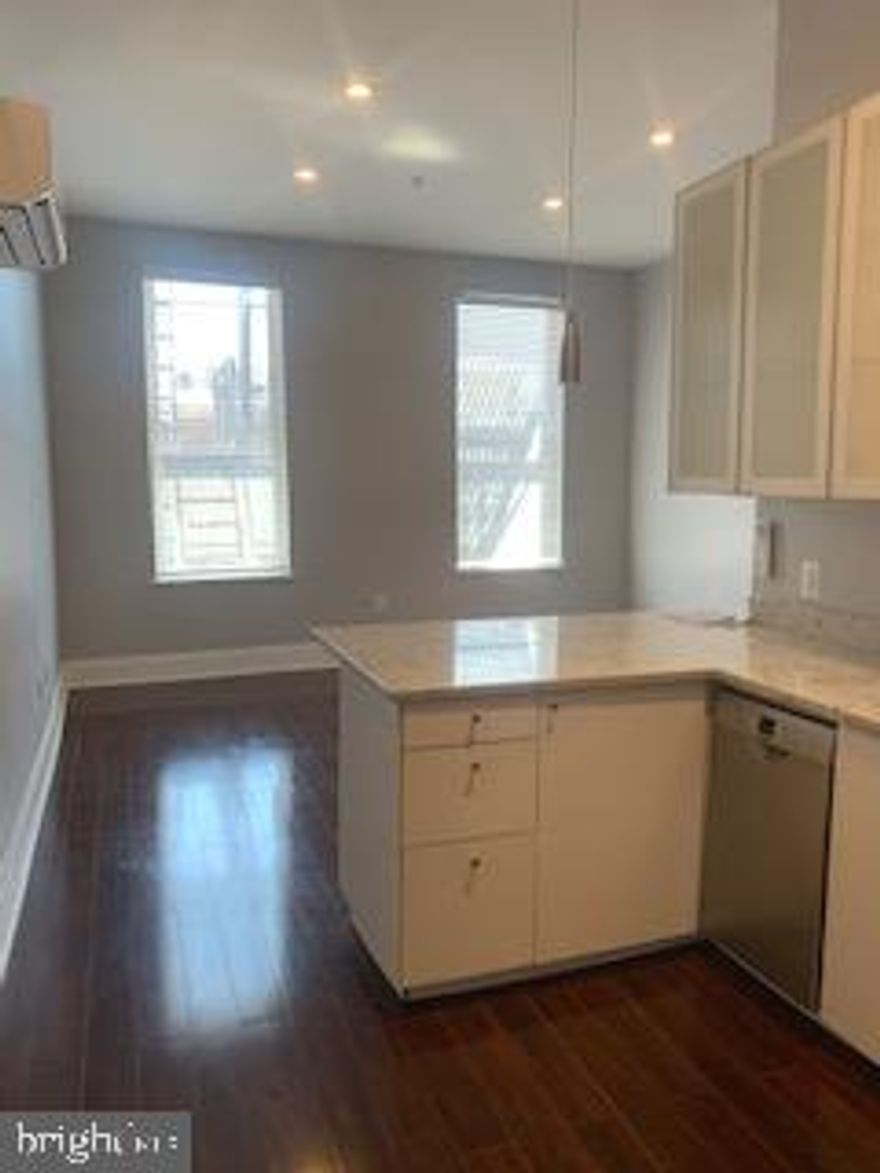 Stylish Studio Apartment with Hardwood Flooring,  White Kitchen Cabinets with Granite Countertop, Stainless Steel Appliances including the combination Microwave/Convection Oven (no stove), Stacking Washer/Dryer, Full Bathroom, Mirrored Double Door Closet and Amocam Video Intercom System.