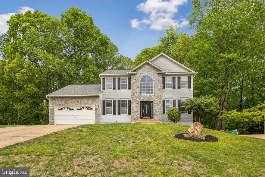 PRICED TO SELL.  $150k lower than new home development across from this community and more square footage. No home to sell contingencies.

Immaculate Colonial on Nearly Half an Acre Backed to Woods!
Discover over 5,000 sq ft of living space in this stunning 6-bedroom, 3.5-bath stone-front colonial, nestled on a private .46-acre lot with a fully fenced backyard. This move-in-ready home boasts 3 fully finished levels with fresh paint throughout and luxury vinyl plank flooring on the main level.

Step into a grand 2-story foyer with a sweeping staircase with private office and elegant living and dining rooms. The gourmet kitchen features granite countertops, stainless steel appliances, a cooktop island, and generous table space—plus a walkout to a private deck with serene wooded views. The adjacent family room is bathed in natural light with floor-to-ceiling windows and a cozy fireplace.

Upstairs, retreat to an oversized primary suite with an expansive walk-in closet and spa-style bath featuring a soaking tub, walk-in shower, dual vanities, and private water closet. The secondary bedrooms are carpeted and share a spacious hall bath. Upgrades Galore.

The fully finished lower level includes two additional bedrooms, a full bath, and a large laundry room—perfect for a guest suite, in-law retreat, or multigenerational living. Walk out to a fully fenced backyard that backs to mature trees.

This home has it all: size, privacy, elegance, and flexibility for today's lifestyle!