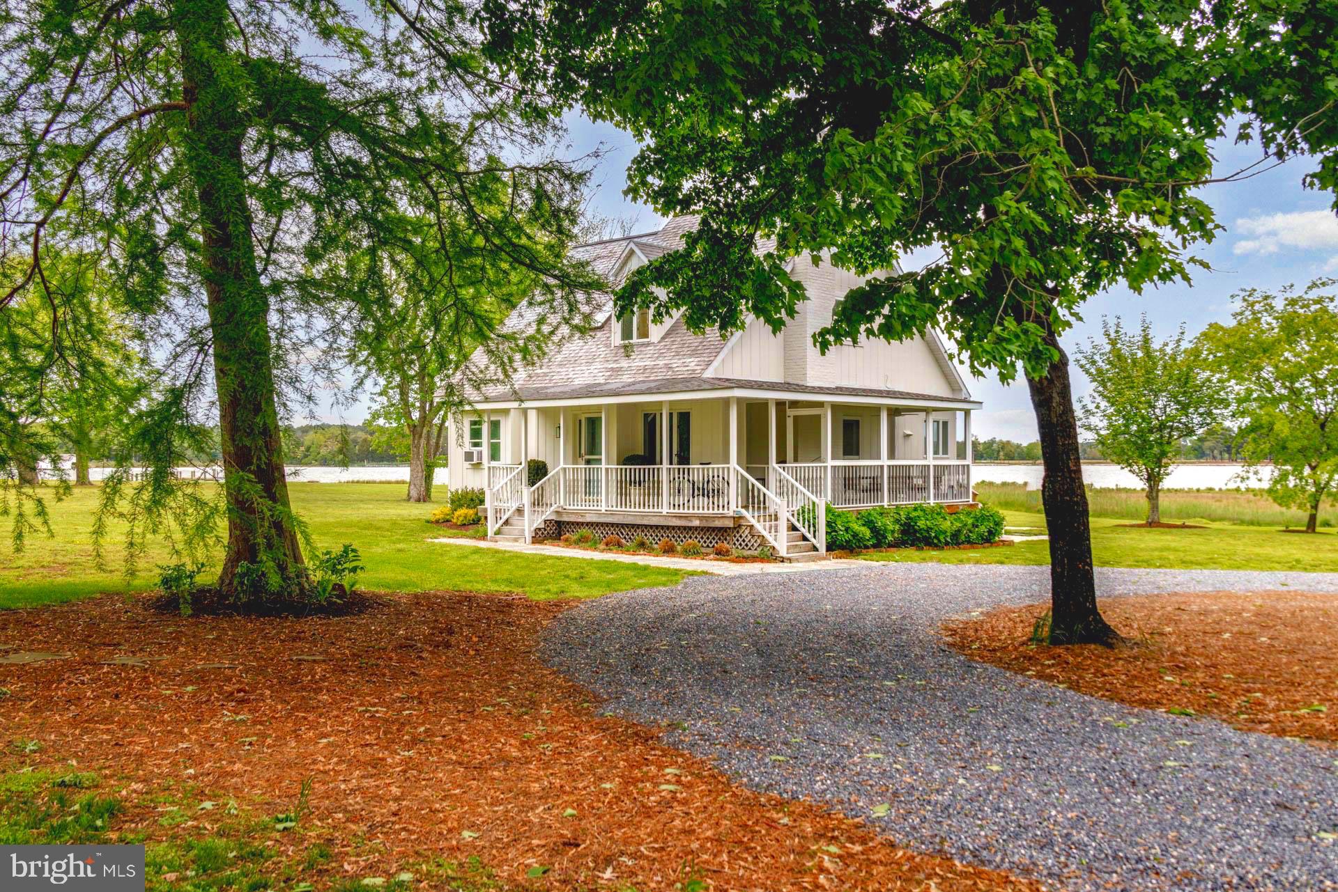 Located between Easton and Oxford, this absolutely charming 3BR cottage is sited on 3.8 acres with spectacular panoramic western views. Incredible SUNSETS over the Tred Avon River! Open floor plan on the first floor with living room , kitchen and dining areas all opening to porches/decks. Two comfortable bedrooms share a full bath as well. Upstairs is a stunning master suite with high ceilings and views of the river, complimented by a private deck.
Current owners have constructed a brand new pier offering 6'MLW (with electric and water) and Lift plus created a sandy beach. Should someone wish to build or expand, the lot offers 100' building setback line from water and 25' sideline setback. An designated sewage reserve area has been approved and the building site is out of the flood zone due to good elevation. Plenty of room for a pool!
The road maintenance agreement is shared equally between property owners.