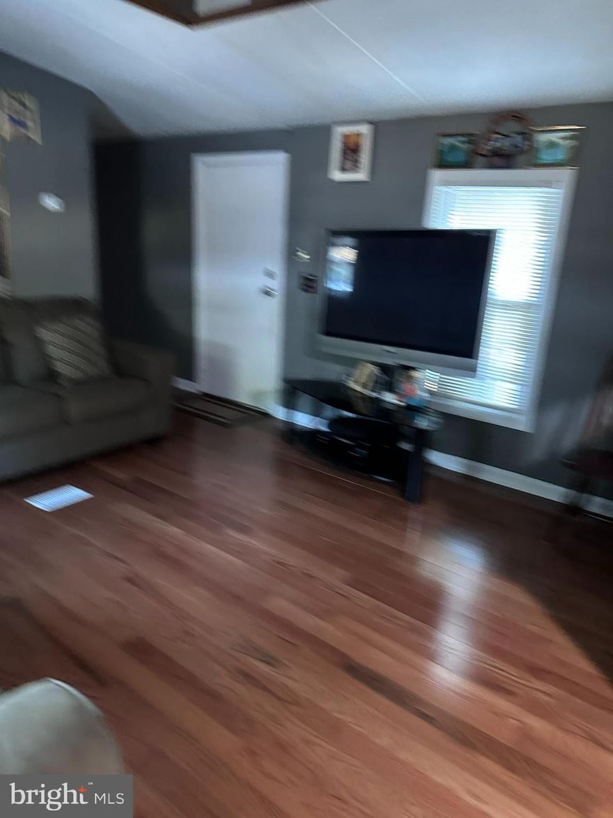 Welcome to this delightful home in the desirable Parkway Village Manufactured Home Community. This home offers a perfect blend of modern convenience and affordability and an excellent opportunity for comfortable living. This property will capture your attention with its convenient location, well-maintained interior, and range of amenities. This delightful residence offers a comfortable and affordable housing option, boasting ample living space, modern features, and a convenient location. As you step inside, you are greeted by a bright, airy, open-concept living area that seamlessly combines the living room, dining area, and kitchen. The large windows flood the space with natural light, creating a warm and inviting atmosphere for relaxation and entertainment. The home offers three spacious bedrooms, providing plenty of room for everyone to enjoy their privacy and unwind after a long day. The primary bedroom features a generous closet and En-suite bathroom for added convenience. Outside, the property boasts a private yard area, perfect for outdoor activities, gardening, or simply enjoying the fresh air. You'll appreciate having a dedicated parking area right on the premises—easy access to many amenities, including shopping centers, restaurants, parks, and schools. Commuting is a breeze, with major highways and public transportation options just moments away. Take advantage of the opportunity to own this fantastic manufactured home in the highly sought-after Maryland City neighborhood. Whether you're a first-time homebuyer, downsizing, or looking for a wise investment, this property checks all the boxes. Schedule your showing today and make this house your home!