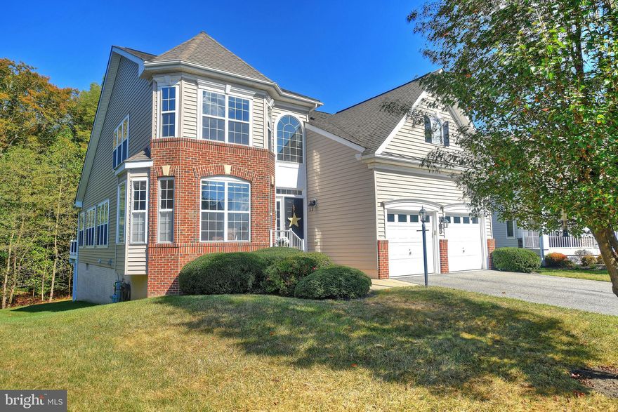 This beautiful Bulle Rock single family home with all the bells and whistles is tucked away in a quiet cul de sac and backs to trees for great privacy in the yard.  Gorgeous Turnbury model with a turret front elevation, and open floor plan has been expanded with bump-outs on the front, side and rear of the home.  The rear sunroom bump-out opens to the maintenance free double deck overlooking the woods.  Imagine the fun with the Hot Tub (3 year old, 4 person, with integral lighting, sound and blue tooth) which can be accessed from the sun room or the custom door in the MBR! The entire first level features exquisite Brazilian Cherry hardwood floors. The gourmet kitchen, with granite counters and stainless appliances, has a great breakfast room that is currently used as a bistro type lounge area.  The main level master bedroom features a door to the deck and quick access to the hot tub on snowy nights!  The upper level has a large loft, 2 more bedrooms (both with walk-in closets) and a hall bath.  The fully finished walk out lower level features a possible 4th BR for guests, a full bath and a newly finished club room with brand new carpeting.  So many extras... Central Vac, custom California Closets in all bedrooms...MORE!  This very special home has been meticulously maintained and is ready for it's new owner!  Enjoy the Bulle Rock resort style lifestyle within the gated community with 24 hr. security, which includes world class golf on a Pete Dye designed course, the on-site Gourmet Pub & Grill, social clubs, community events, a spectacular recreation center with a full gym, indoor & outdoor pools, tennis courts and walking trails. Come live where "Life Imitates Vacation!"