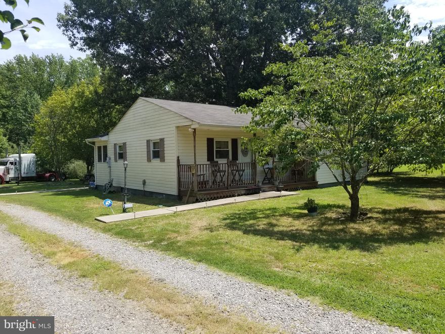 Wall was removed that separates the third bedroom from the living room. That wall can be reinstalled to make it a three bedroom again, if the buyer wants three BR.  That room could be 13 x 10. Sold as is, but shows well. Septic is located to the right of the home in the cleared area. Ceiling fans convey. PVC plumbing installed 4 years ago. Work and save or fix and flip. New well pump and holding tank in April of this year. Pine floors in most rooms. Enclosed rear porch, Covered front porch. Detached 2 car metal carport. Septic pumped less than two years ago.