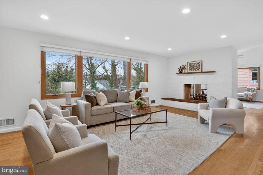 Beautifully renovated Mid-Century Modern home in Kenwood Park, offering an exceptional blend of warmth, natural light, and modern convenience. Thoughtful updates are found throughout, including Leicht German cabinetry and Caesarstone countertops in the kitchen and bathrooms. The kitchen is both stylish and functional, featuring excellent storage, upgraded appliances, and direct access to the two-car carport.

A striking two-sided wood-burning fireplace anchors the main living spaces, adding warmth and character to both the living room and the vaulted-ceiling den. The den opens to a spacious deck with stairs leading to a flagstone patio and fire pit—ideal for entertaining or relaxing outdoors—and may also serve as an elegant formal dining room.

The main level includes four bedrooms and two full bathrooms, providing comfortable and convenient living. The walk-out lower level offers remarkable flexibility with a large recreation room centered around a second wood-burning fireplace and sliding doors to the patio. A versatile kitchenette/craft room—complete with an additional refrigerator, freezer, and full-size washer and dryer—creates space for hobbies, entertaining, or multigenerational living. This level also features a second den, a third full bathroom, and a fifth bedroom, perfect for guests, a private office, or a home gym.

Timeless Mid-Century design, inviting indoor-outdoor spaces, and modern functionality come together beautifully in this exceptional home.