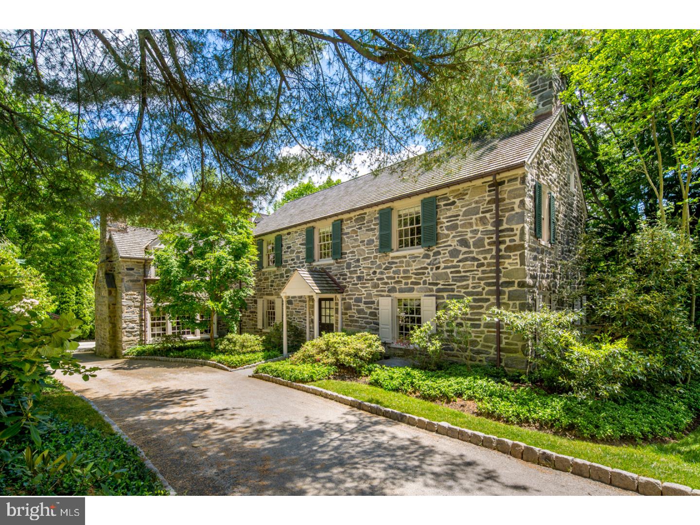 Enchanting, elegant home on breathtaking grounds with a swimming pool for entertaining & large, level, fenced lawn for the family to play in Bryn Mawr's best location. This quintessential classic Colonial set on a lovely quiet lane is meticulous, boasting cedar roof, Belgian block-lined drive & grand multicolored stone fa ade that will capture your heart. Tastefully renovated/expanded by highly respected Griffiths Construction, this home is a fabulous family haven. A transverse hallway with coat closet opens to a spacious living room graced by random-width oak floors, sunny triple exposures, a wood-burning fireplace to cozy around & a door to the flagstone terrace for lounging & dining in nature. The dining room and kitchen also open to the terrace, inviting an indoor-outdoor flow. Serving is easy thanks to a windowed butler's pantry, which connects to the gourmet kitchen, equipped with cabinets, a sink, granite counter & dishwasher. An awning provides both shade and protection from the rain. Family & guests can congregate in the center island kitchen as the cook chats & prepares meals. Granite counters, backsplash & peninsula, top-name appliances & a walk-in pantry make this any chef's favorite, and a great spot for get-togethers over snacks or hors d'oeuvres. Double doors from the adjacent windowed breakfast room escort you out to the flagstone terrace for enjoying morning coffee. Kitchen pocket doors lead to the knotty pine-paneled den that can be entered from the hallway & family room as well. Built-in cabinetry & shelving are complemented by a wood-burning fireplace for reading & relaxation. The cherry-wood-encased family room with a gas fireplace is a warm, inviting place to gather. The main level also offers a powder room & mudroom with closet that conveniently accesses the attached 2-car garage, lush property & pool area. Rear stairs ascend to a half level with a BR, full bath & laundry room. The main staircase with chair rail detail rises to the 2nd floor oak wood hallway. The vaulted master suite addition is a stunning retreat with painted ceiling beams, plush wall-to-wall carpeting, a wood-burning fireplace, built-ins, 2 closets including a walk-in & luxurious sky-lit spa bath. Three additional BRs (2 en-suite, 1 w/fireplace) a hall bath & abundant storage complete the comfort. A large unfinished attic, lower level with fireside rec room, powder room, kitchenette, CAC, security system & wonderful playhouse make this your special home!