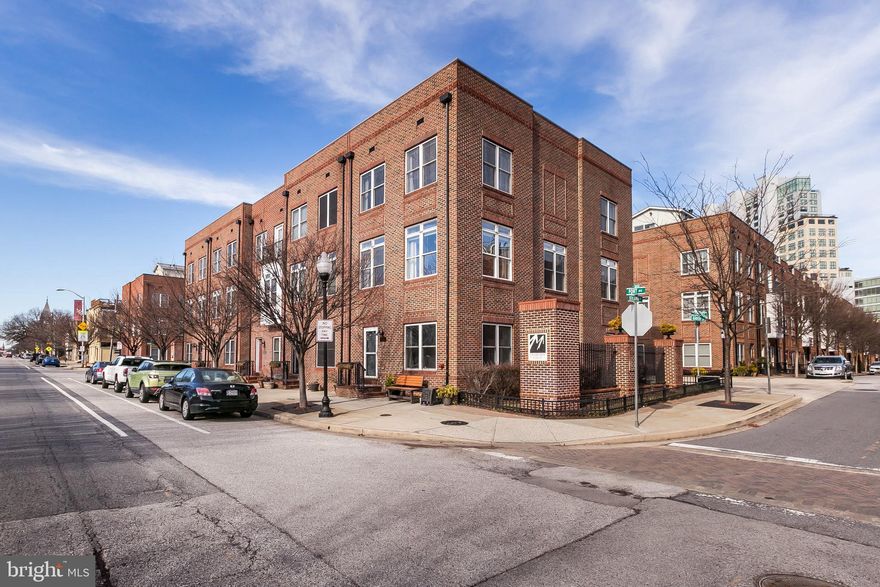 Light-filled, ideally situated, end-of-group McHenry Point townhome. Main level offers an open floor plan with hardwood floors, custom moldings & fireplace. Gourmet kitchen features stainless steel appliances, granite & island. Master suite includes an over-sized walk-in closet & private bath. Lower level includes an office/4th bedroom, powder room, laundry & 2 car garage plus 1 car parking behind the garage. Expansive roof top deck with skyline views.