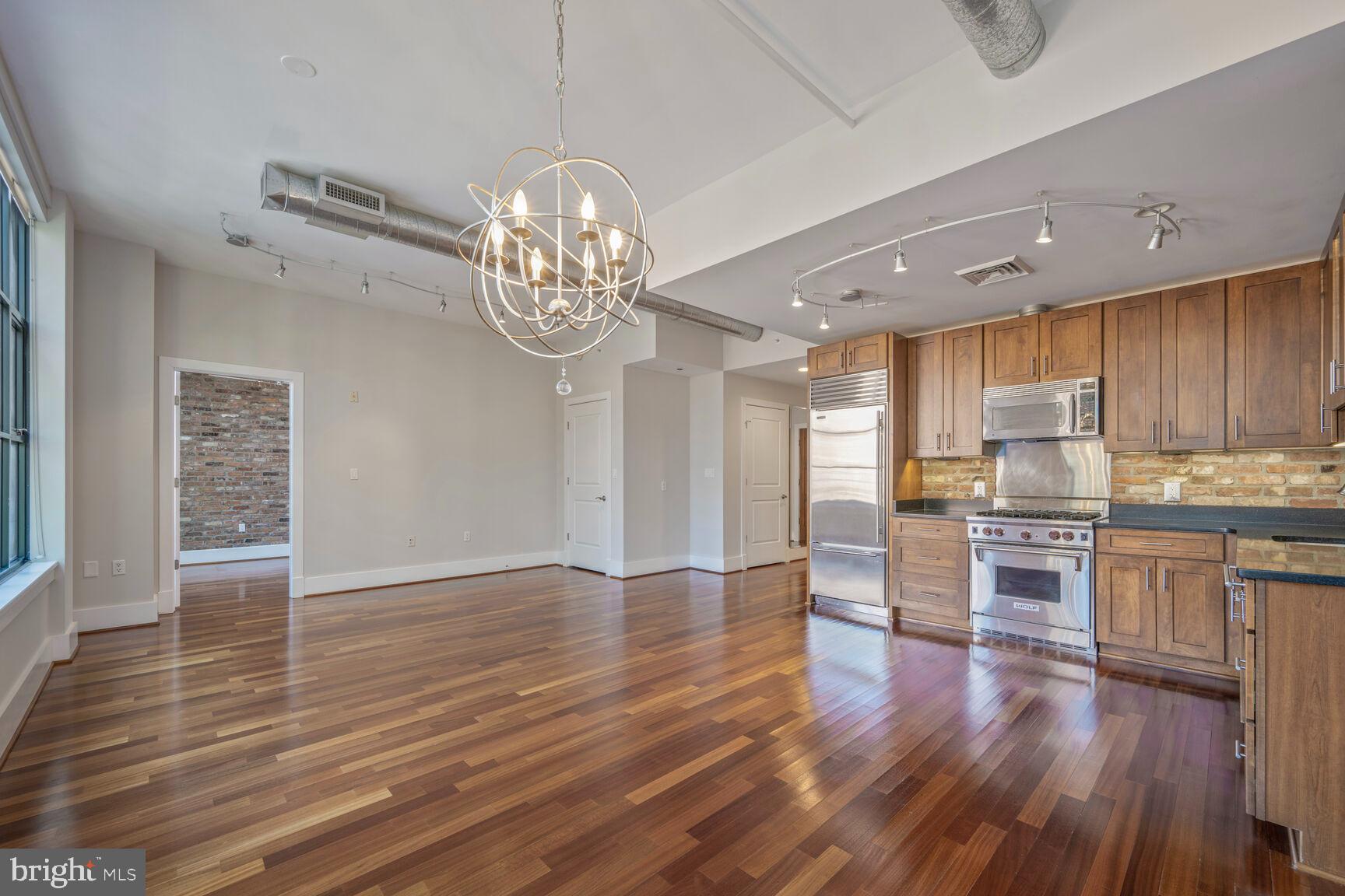 **Luxury 1BR Condo with Premier Amenities in Northern Virginia**
Welcome to this elegant and modern 1-bedroom, 2-bathroom condo nestled in one of Northern Virginia’s most sought-after contemporary buildings. Designed for comfort and style, this sun-filled residence features soaring ceilings, rich wood floors, and a spacious open layout perfect for both everyday living and entertaining. The chef’s kitchen is a standout, equipped with a Sub-Zero refrigerator, Wolf stove, granite countertops, and premium finishes—ideal for culinary enthusiasts. The bright and airy living area is framed by oversized windows that flood the space with natural light, creating a warm and inviting atmosphere. The generously sized primary suite includes a spa-like full bath, while a second full bathroom adds flexibility for guests. Residents enjoy access to top-tier amenities including a front desk attendant, resort-style pool, fully equipped fitness center, business center, game room, and private garage parking with one dedicated space included in the rent. This is refined condo living with a modern edge—an exceptional opportunity to enjoy comfort, convenience, and luxury in Northern Virginia.