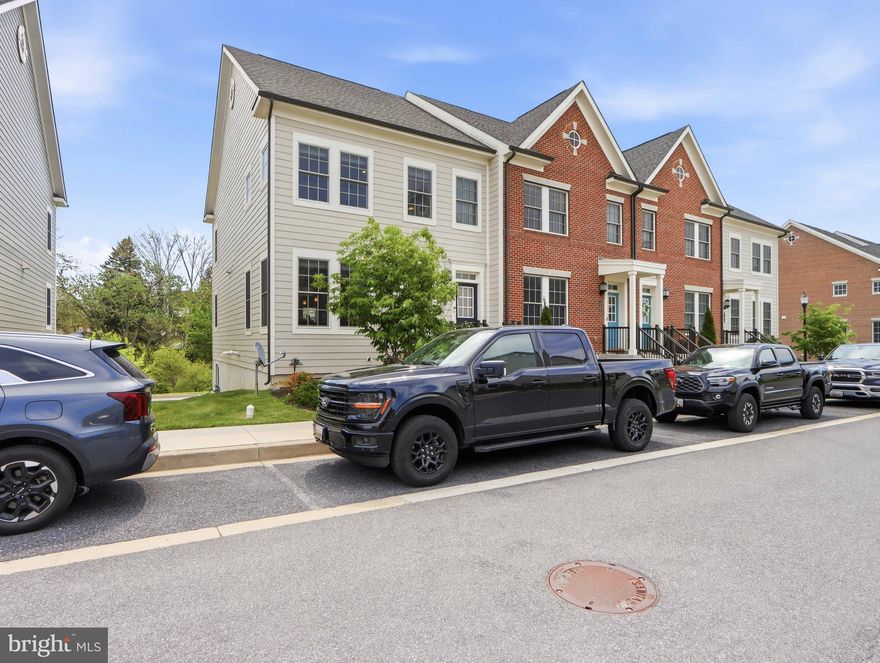 Welcome to 7288 Conley Alley, nestled in the highly desirable community of Parkside at Warfield.   This  6 year old 2332 sq.ft end unit is bigger than interior units.  This beautifully maintained, like-new home showcases neutral finishes and thoughtful upgrades throughout. Open concept layout main level featuring luxury vinyl plank flooring, recessed lighting, a large living room, impressive center kitchen with long island and a dining room.    The upgraded kitchen is a true showstopper with 42" white cabinetry, quartz countertops, a massive island with seating and custom pendant lighting, a butler's pantry, stainless steel appliances, a separate pantry, dual ovens, and an abundance of storage space. This home has extra many side windows allows natural lights in all day long.   The upper level features a stunning primary suite with custom moldings, coffered ceiling, a generous walk-in closet, and  a walk-in shower, bench seating, dual vanities, and tasteful fixtures. Two additional spacious bedrooms offer ample closet space, and you'll also find a second full bath and laundry on this level for added convenience. Bright and airy family room is flooded with natural light,   Lower level recreation room has additional open space with a full bath.  The oversized garage is equipped with built-in shelving, an electric vehicle charger.  Parking is a breeze with an attached garage, driveway, and plenty of street parking.   Open front and back space allow total privacy and peace of mind.