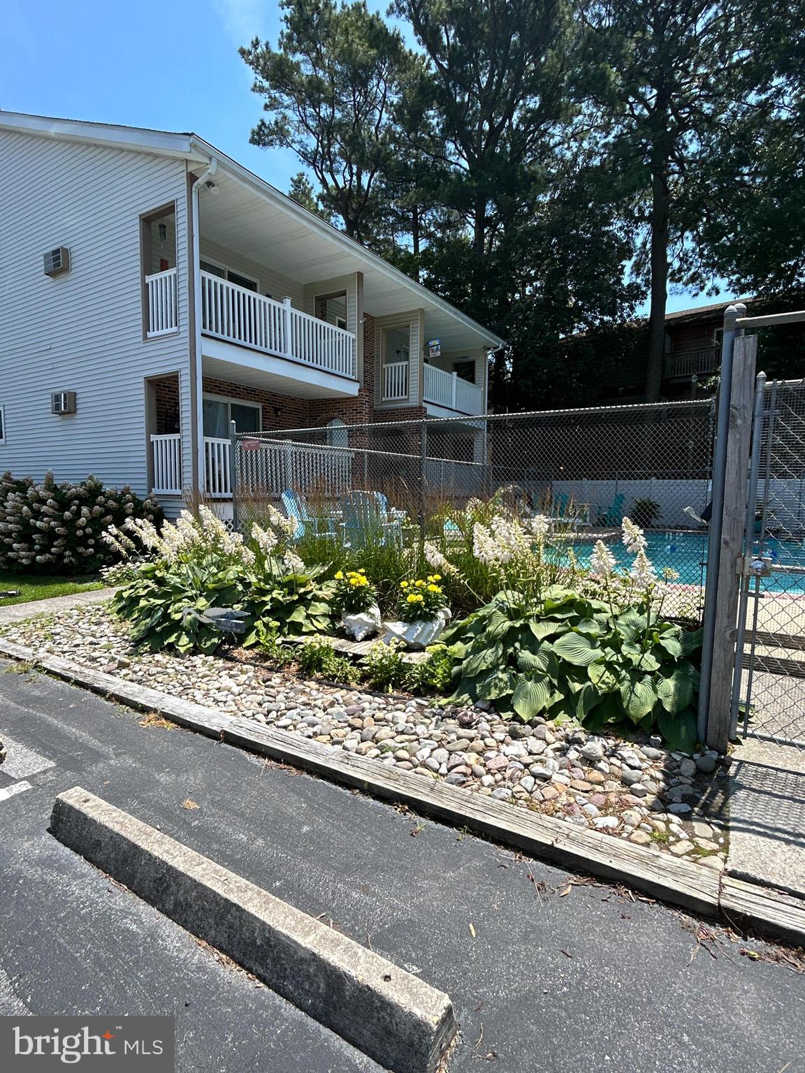 This unique 2-bedroom, 2-bath condo located in the highly sought –after community of Caine Woods in North Ocean City, MD. is unlike any other two-level unit in the Pine Needle complex, this condo is the only one offering central air and heat, ensuring year-round comfort. The HVAC system is just 2 years old, and a commercial-grade water heater adds efficiency and reliability.
The open floor plan is fully furnished and move –in ready. The first floor features a spacious living room ideal for relaxing or entertaining. A bedroom and full bath are also located on the main level, perfect for guests or single-level living.
Step out onto the private balcony, which overlooks the community pool and features high-quality Amish-made poly deck furniture that conveys with the sale—creating a peaceful outdoor space to unwind.
Upstairs, you'll find the second bedroom and full bath, providing additional privacy. This unit is being sold "AS IS", but it's been well maintained and offers plenty of potential for personal touches or rental income.
Located just minutes from the beach, bay, restaurants, and shopping, this condo puts you close to everything Ocean City has to offer, all while tucked into a quiet, residential neighborhood. Whether you're looking for a vacation getaway or a low-maintenance primary home, this one-of-a-kind condo in Pine Needle is the one you will want to see.