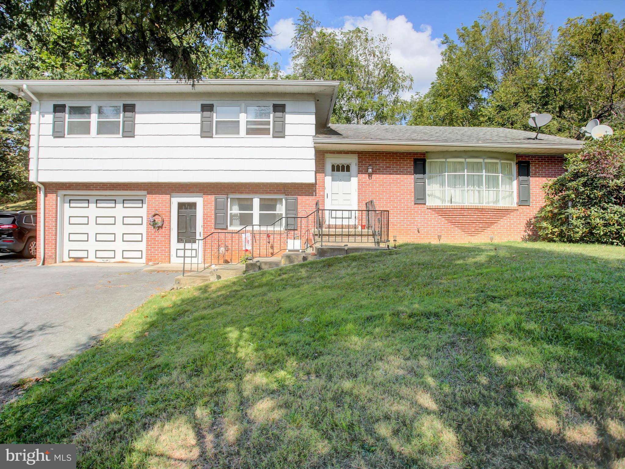 Located in the heart of Five Forks along State Route 316, this exceptional mixed-use property offers a rare blend of residential comfort and commercial opportunity. Zoned Village District in Quincy Township, it supports a wide range of uses including retail, office, service-based businesses, and residential living. The split-level home features four levels of living space, including three spacious bedrooms, one and a half baths, a large living room, and a combination kitchen and dining area. Additional highlights include a cozy family room with a woodstove, a lower-level recreation room, utility room, home office, sunroom, and a one-car garage. Adjacent to the residence is a 1,400 sq. ft. retail space, formerly used as an upholstery shop. This flexible building is separately metered for electric, equipped with a heat pump, central air conditioning, and a propane fireplace. It also has its own well and septic system, along with a private office, bathroom, showroom, workshop area, and a garage/loading bay. The property includes a 36’ x45’ Morton pole building with secure fenced storage and three bays, a storage shed with a metal roof, and approximately four acres of tillable land. The remaining acreage is mostly wooded and features a small creek, adding natural charm to the setting. A 20-foot gravel drive provides access, with a right-of-way easement between the shop and pole building serving two rear properties. This is a sought-after opportunity for entrepreneurs, investors, or anyone seeking a live/work lifestyle in a peaceful village setting. With its prime location, flexible zoning, and abundant space, this property is ready to accommodate your vision. Property being sold "As-is" condition. Sale contingent on owner finding home of choice.