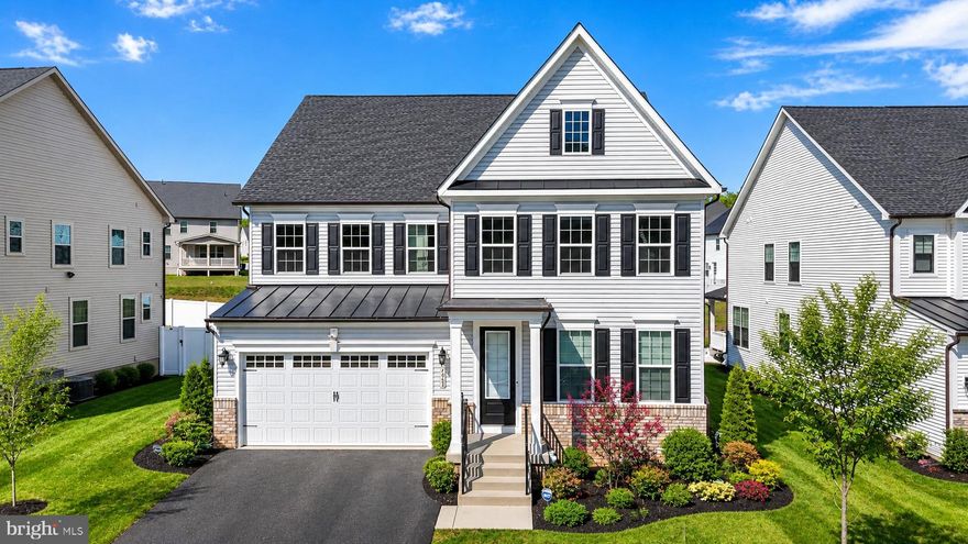 Welcome to 7949 Lawndale — a rare offering that defines what luxury living in Columbia, Maryland was always meant to be. Positioned within the highly sought-after Cedar Creek community and zoned to the acclaimed River Hill High School and Clarksville Middle School, this exceptional NV Homes Tyler model delivers over 5,200+ square feet of meticulously curated, fully finished living space where every detail has been elevated, refined, and executed with intention. From the moment of arrival, the stately white façade with bold black shutters and an inviting covered portico sets a tone of quiet sophistication, complemented by a two-car garage, expansive driveway, and a flat backyard backing to protected open space offering rare privacy and serenity. Inside, sun-drenched interiors showcase wide-plank 9.5” luxury vinyl flooring, a calming neutral palette, crown molding, and upgraded lighting throughout. The foyer introduces refined formal living and dining spaces before transitioning into a truly exceptional chef’s kitchen featuring an expansive quartz center island, 42” snow-white soft-close cabinetry, designer backsplash, and top-tier stainless steel appliances including a five-burner cooktop, double wall ovens, and externally vented hood, along with a coffee station, oversized walk-in pantry, and seamless connection to the mudroom and garage. The adjoining breakfast area and grand family room are filled with natural light and extend effortlessly to the outdoor living space, creating the perfect setting for indoor-outdoor entertaining. Upstairs, the owner’s suite is privately tucked behind French doors and features tray ceilings, plush carpeting, and dual walk-in closets, while the spa-inspired bath offers a jetted soaking tub, frameless glass shower, dual vanities, and private water closet. A rare upper-level loft adds flexibility for a media lounge or office, while three additional bedrooms include a private en-suite and a Jack-and-Jill bath, complemented by a well-appointed laundry room. The fully finished lower level (2024) expands the home’s versatility with a sprawling recreation space, bonus/media room pre-wired for a projector, full upgraded bath, ample storage, and walk-up access. Additional upgrades include a whole-house humidifier, dual Nest thermostats, insulated dual-pane windows, smart lighting, moisture-barrier carpet padding, custom window treatments, active radon system (2024), and EV charger. Cedar Creek offers scenic trails, playgrounds, and open green space, all within minutes of US-29, I-70, and I-95 for effortless access to Baltimore and Washington, D.C. Turnkey. Impeccably maintained. Thoughtfully designed. 7949 Lawndale is where elevated living meets effortless luxury.