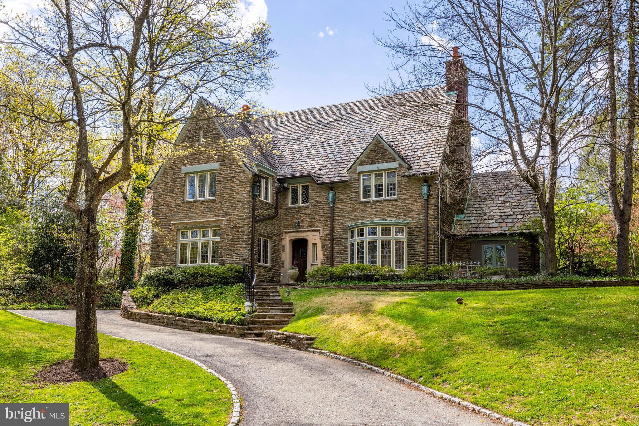 This is the one you have been waiting for! Back on the market due to a change in personal circumstances for the first buyer and not due to inspections or any other contingencies. This stunning and stately West Mount Airy single with beautifully landscaped backyard in a totally dreamy location across the street from Carpenters' Woods! Experience timeless elegance in this distinguished 5-bedroom, 3.5-bathroom home occupying nearly half an acre of beautifully landscaped yard and gardens. A long driveway welcome you home and leads up to a detached 2-car garage with additional driveway parking. The front door opens into a foyer with a grand turned staircase, flanked by an elegant living room to one side, and formal dining room to the other, both adorned with original millwork and stained glass bay windows. The living room has beamed ceilings, built-in bookshelf and wood-burning fireplace, creating a warm and inviting atmosphere. Adjacent, a versatile bonus room complete with its own private entrance is an ideal for a home office. The dining room is a gracious space that opens into the kitchen, featuring Viking stove, Sub-Zero refrigerator, double ovens, and a central island. This opens onto a sun-drenched, all-purpose family room with skylight, an idyllic spot to enjoy a meal, or just hang out as a family, with direct access to the stunning bluestone patio, professionally designed and landscaped gardens with irrigation system, and the huge flat yard. Upstairs, the primary suite features two spacious walk-in closets (one cedar-lined) and en suite bathroom with Art Deco double sink vanity, separate toilet area and a shower/tub combo. Two additional spacious bedrooms occupy this floor with a full Jack and Jill bathroom. The third floor offers 2 additional bedrooms both with built-ins, and a fully renovated hallway bath. The basement is home to laundry and plenty of storage space, and with its high ceilings, it could be finished by the next owner. Located just a few blocks from Weavers Way Co-op, High Point Cafe and the rest of Mt. Airy Village, with the trails of the Wissahickon and the Allens Lane playground and tennis courts all within a few blocks. Just a few minutes by car to the shops and amenities of Chestnut Hill, this location simply cannot be beat. Quiet and serene setting in the wonderful community that makes West Mount Airy one of the city's most popular neighborhoods. Come and see for yourself!